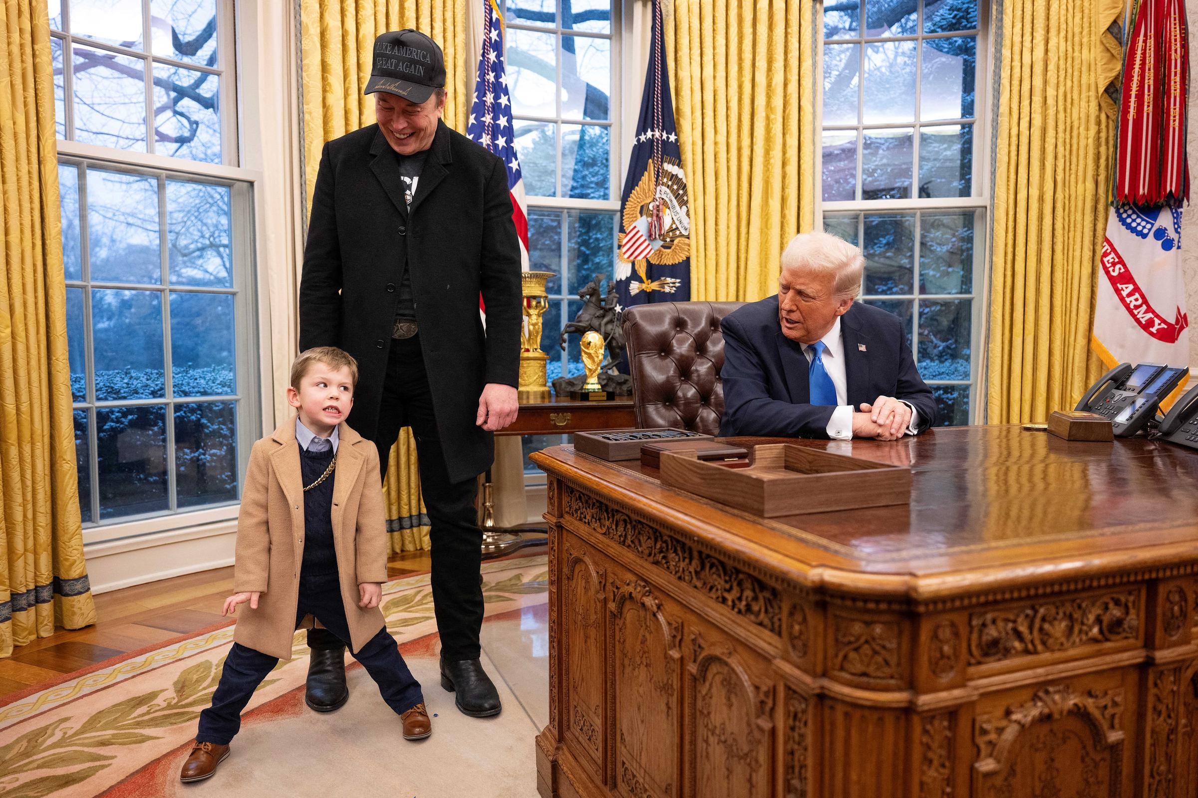 Elon Musk with his son X Æ A-XII standing next to President Donald Trump in the Oval Office in Washington, D.C. on February 11, 2025. | Source: Getty Images