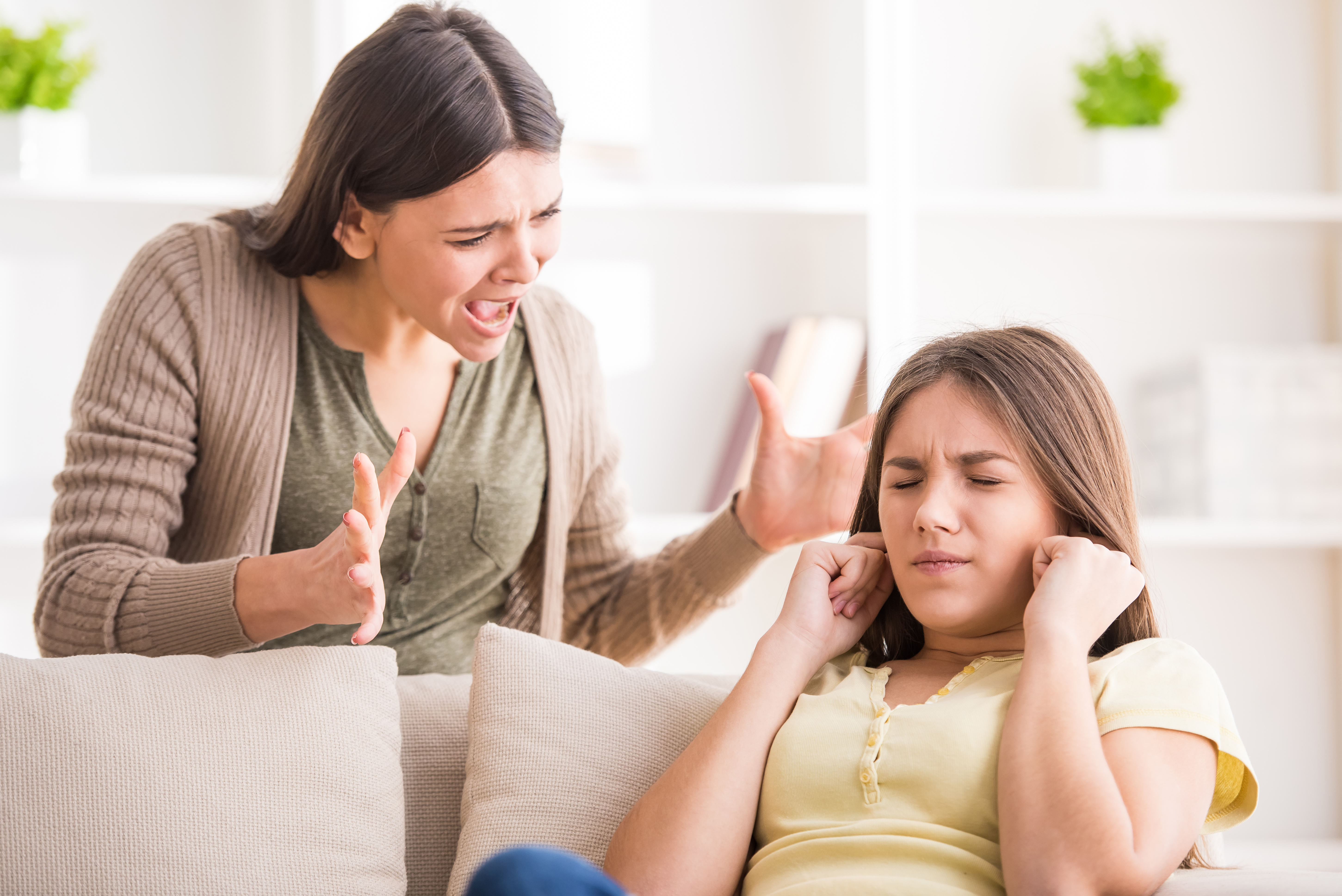 A young woman screams at a teen girl | Source: Shutterstock