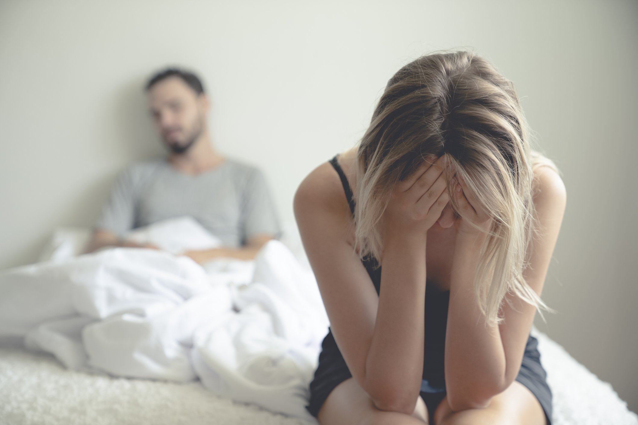 Ausgangstext Frustrierte traurige Freundin sitzt auf dem Bett und denkt an Beziehungsprobleme. I Quelle: Getty Images