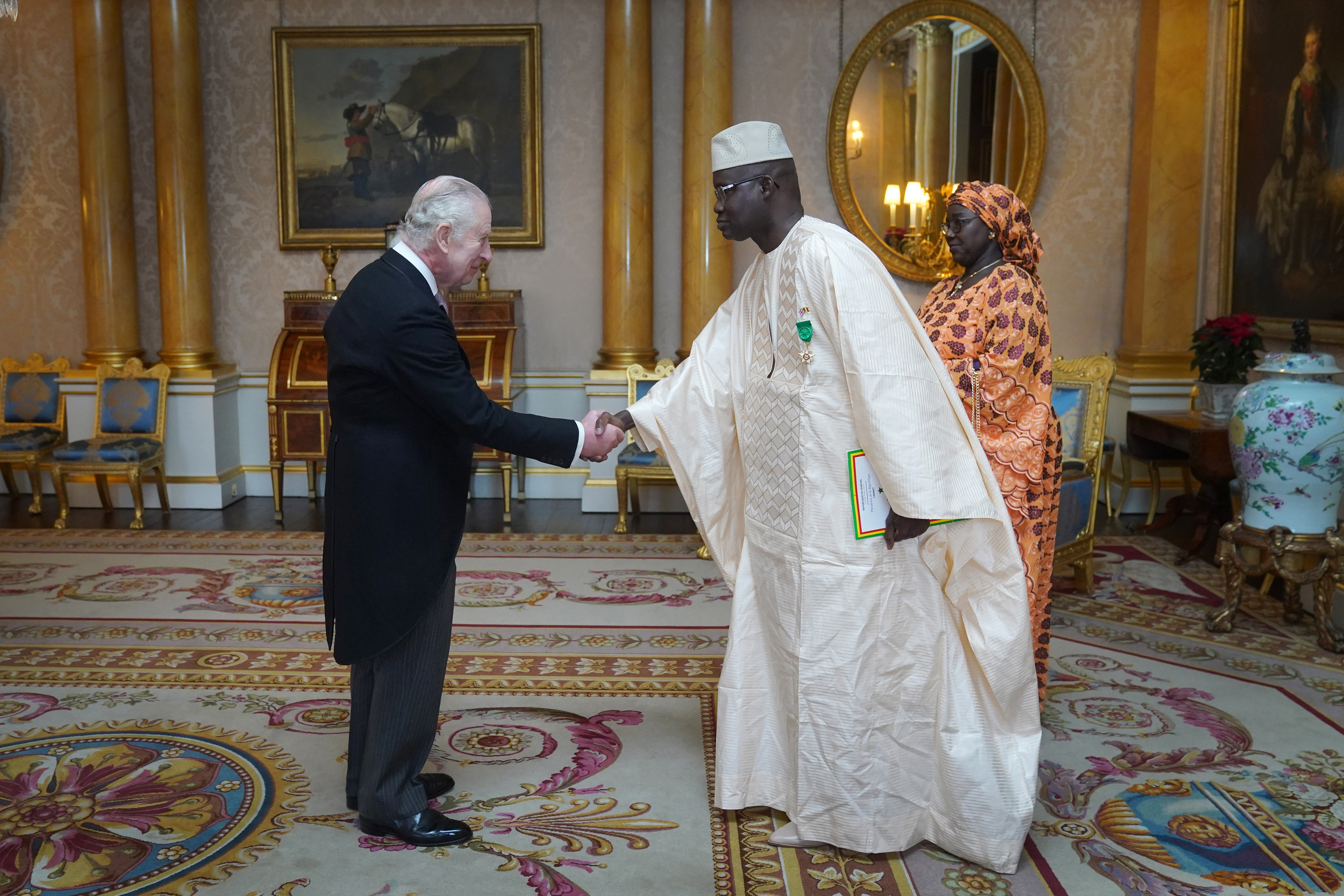 The Ambassador of Senegal, General Cheikh Wade, presents his credentials to King Charles III during a private audience at Buckingham Palace in London on December 13, 2023. | Source: Getty Images