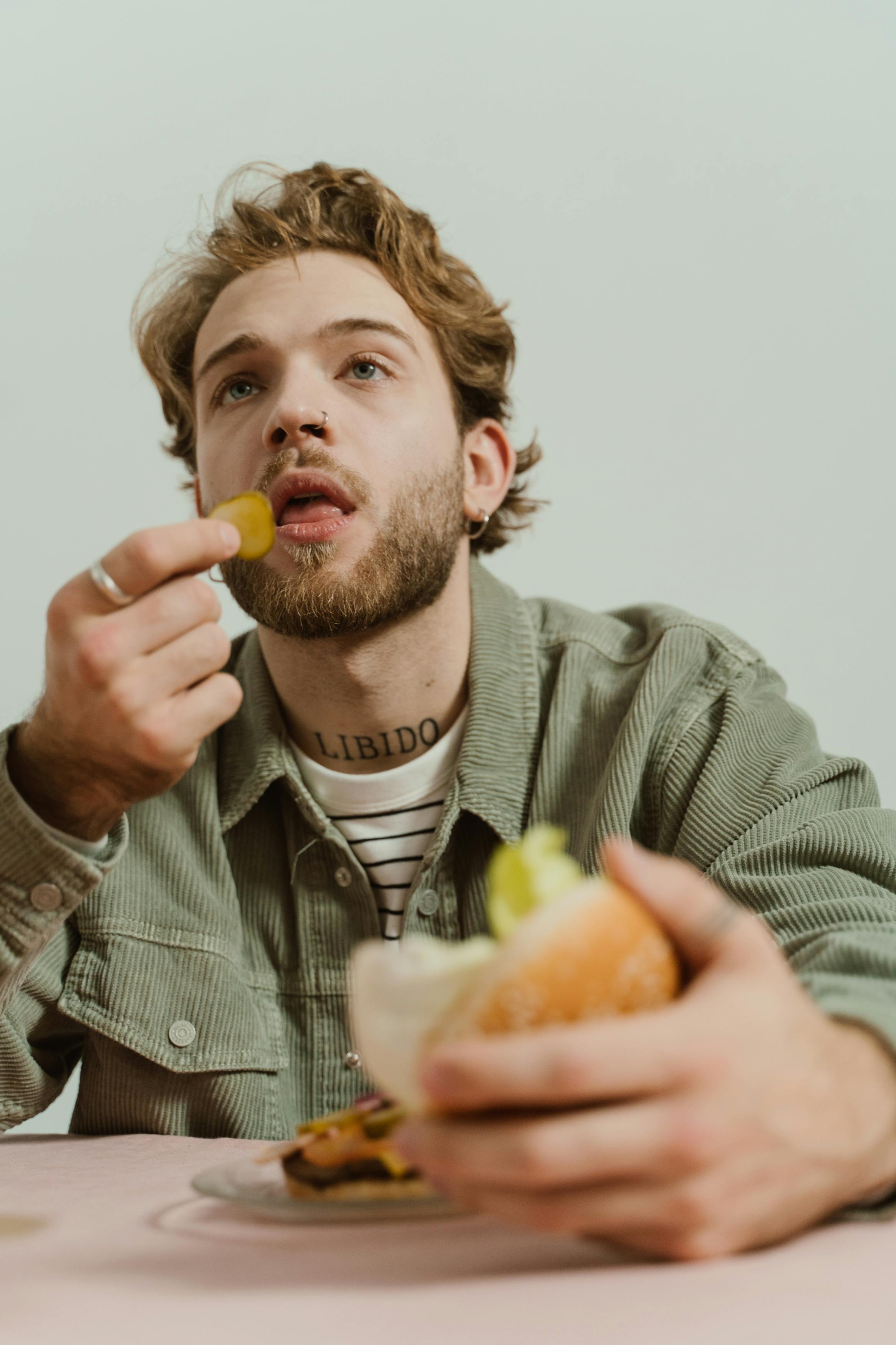 A man eating a burger | Source: Shutterstock