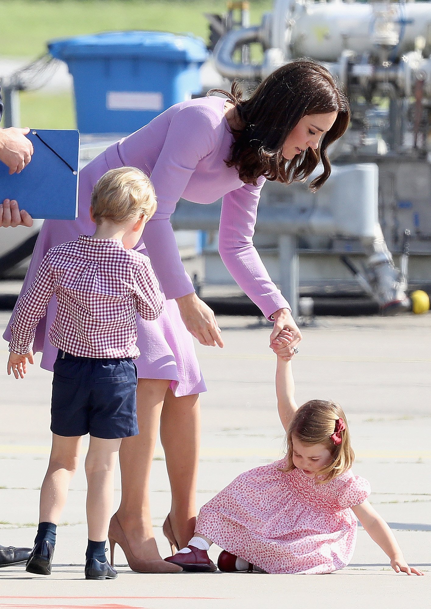 Prince George, Duchess Kate, and Princess Charlotte view helicopter models before departing from Hamburg airport during their official visit to Poland and Germany on July 21, 2017, in Hamburg, Germany | Source: Getty Images