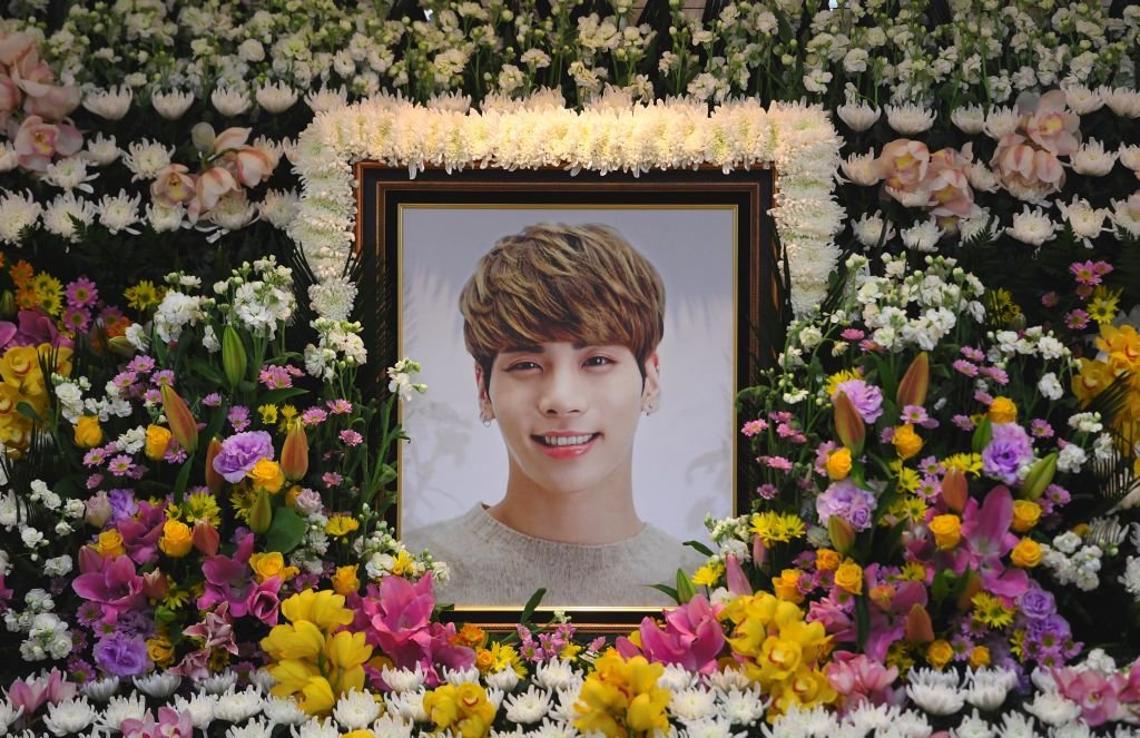 The portrait of Kim Jong-Hyun, a 27-year-old lead singer of the massively popular K-pop boyband SHINee, is seen on a mourning altar at a hospital in Seoul on December 19, 2017. | Source: Getty Images