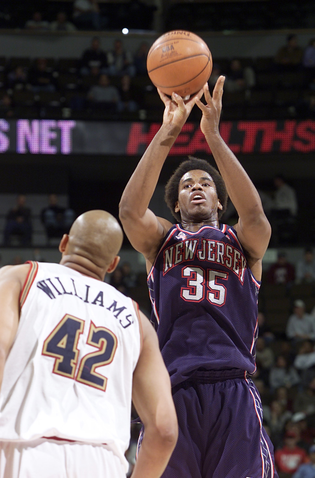 Jason Collins shoots over Scott Williams during the New Jersey Nets game against the Denver Nuggets at Pepsi Center on November 19, 2001, in Denver, Colorado | Source: Getty Images