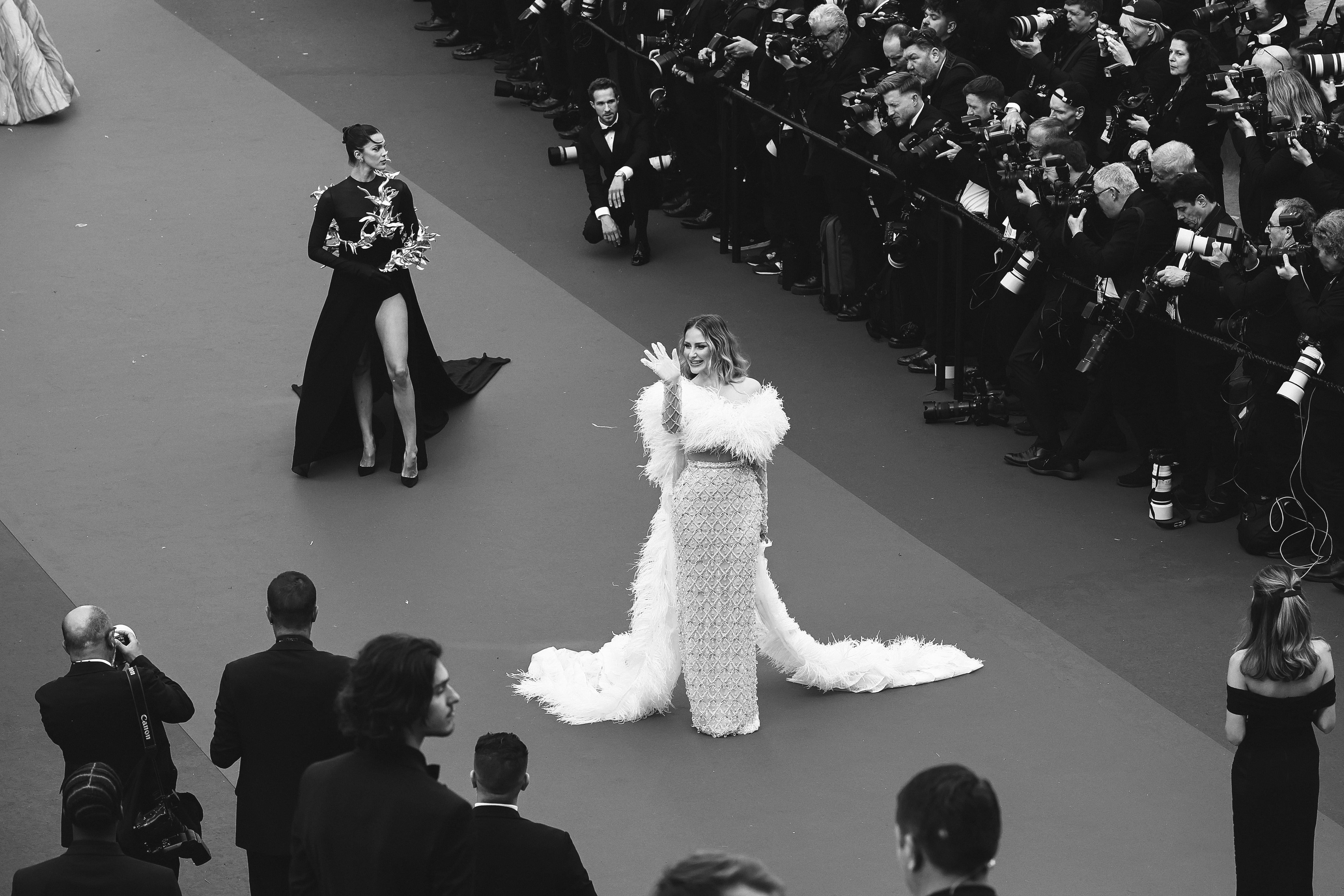 Iris Mittenaere and Caroline Receveur walking down the red carpet at the Cannes Film Festival in 2024 | Source: Getty Images