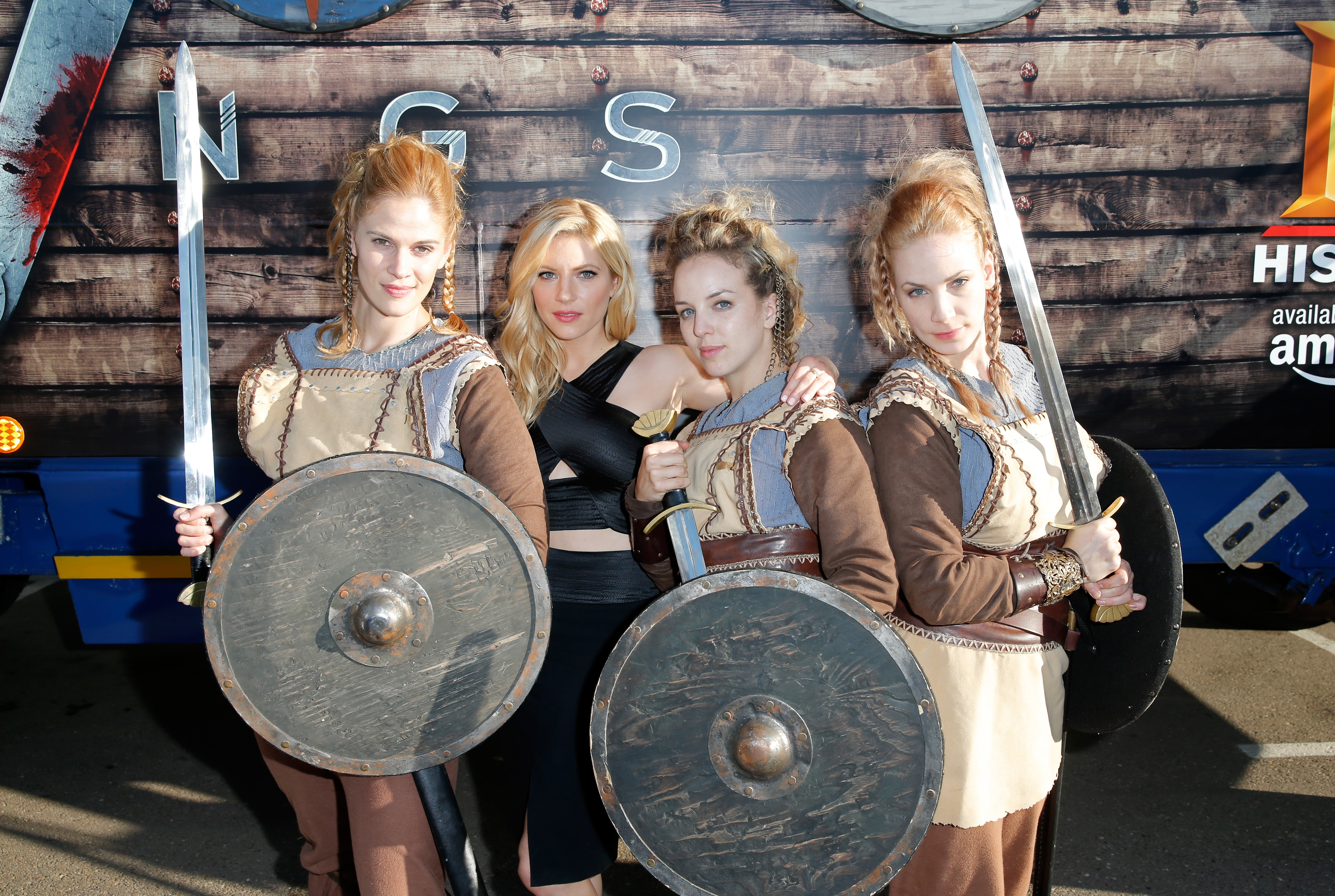 Katheryn Winnick (black dress) and female Viking cosplayers at Comic-Con International in San Diego, California, on July 10, 2015. | Source: Getty Images