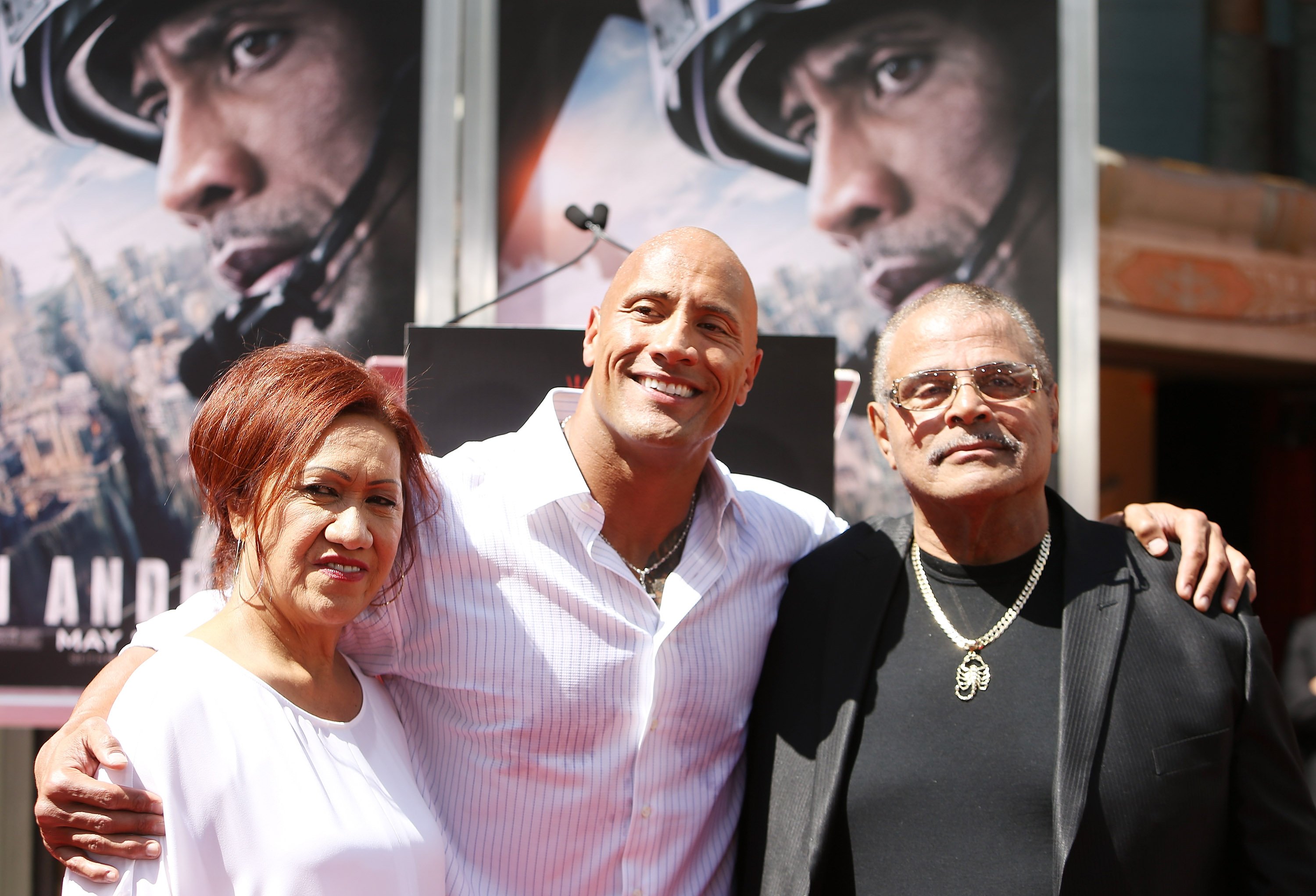 Dwayne "The Rock" Johnson (C) and his mom and dad at the hand/footprint ceremony honoring him held at TCL Chinese Theatre IMAX on May 19, 2015 in Hollywood, California. | Getty Images