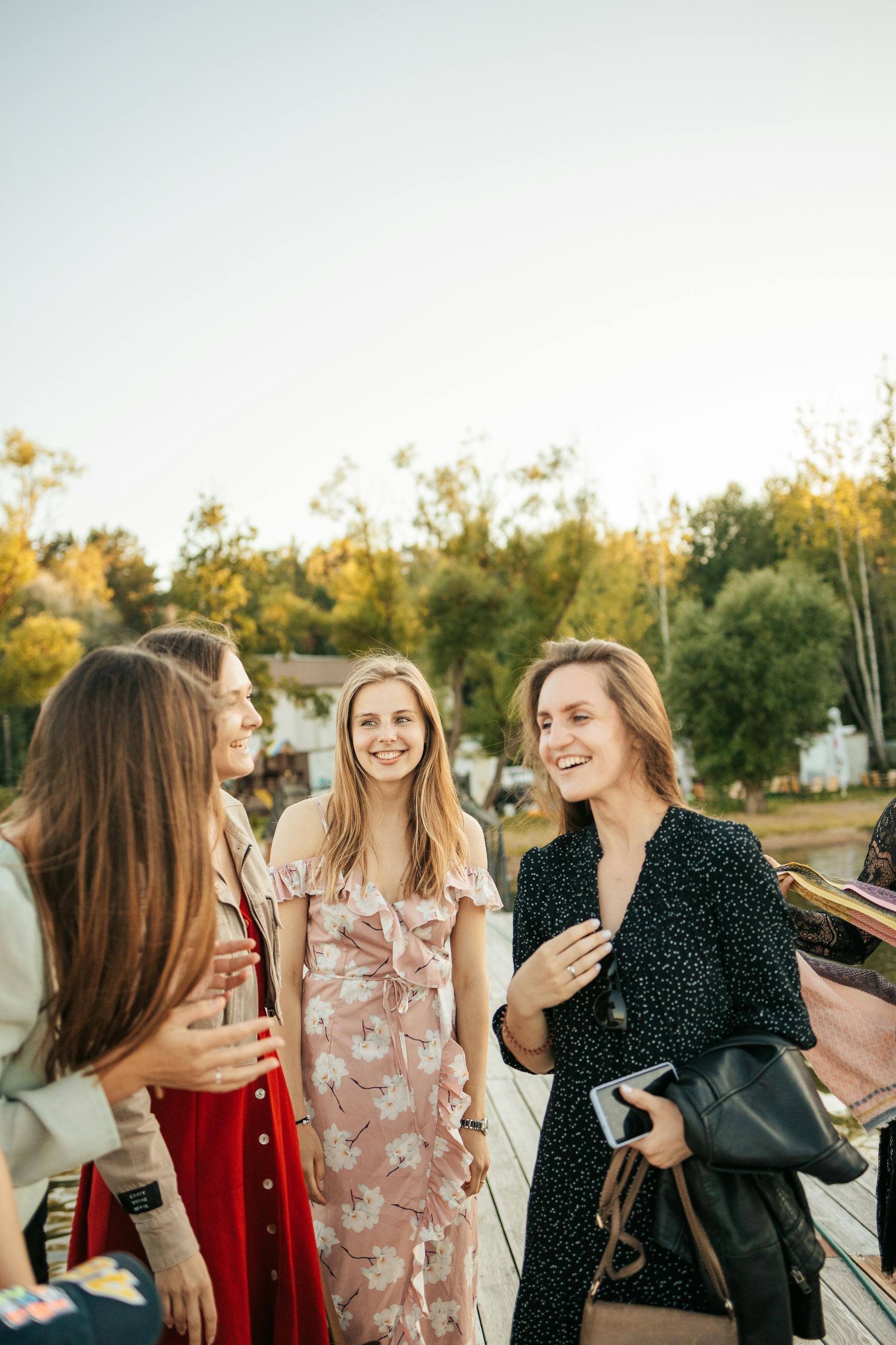 Women laughing while having a conversation | Source: Pexels