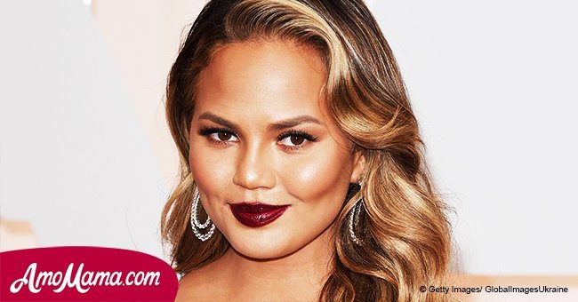 Chrissy Teigen is seen cradling her cute 1-year-old daughter. She looks like such a proud mom