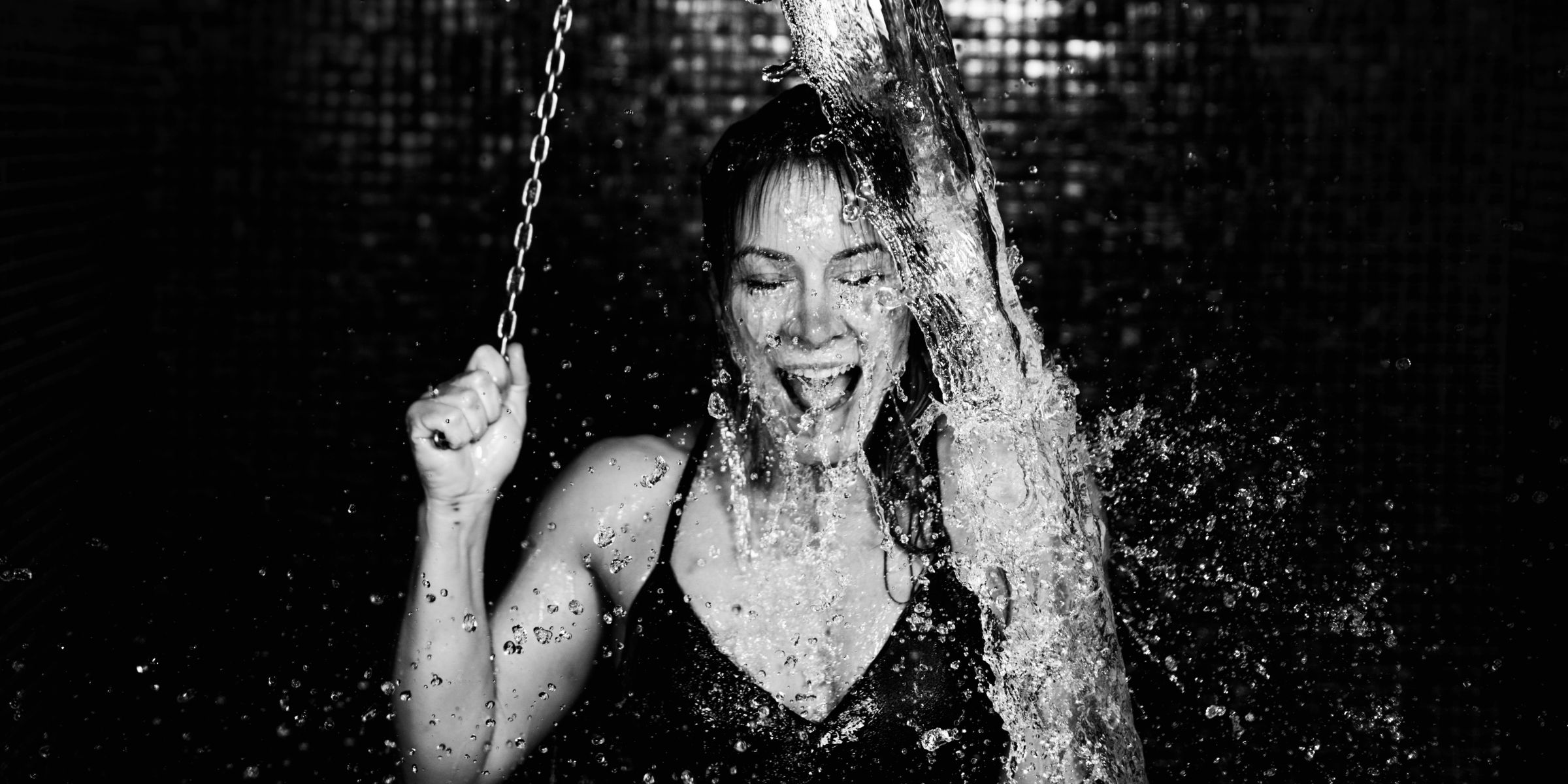 Woman enjoying a cold shower | Source: Shutterstock