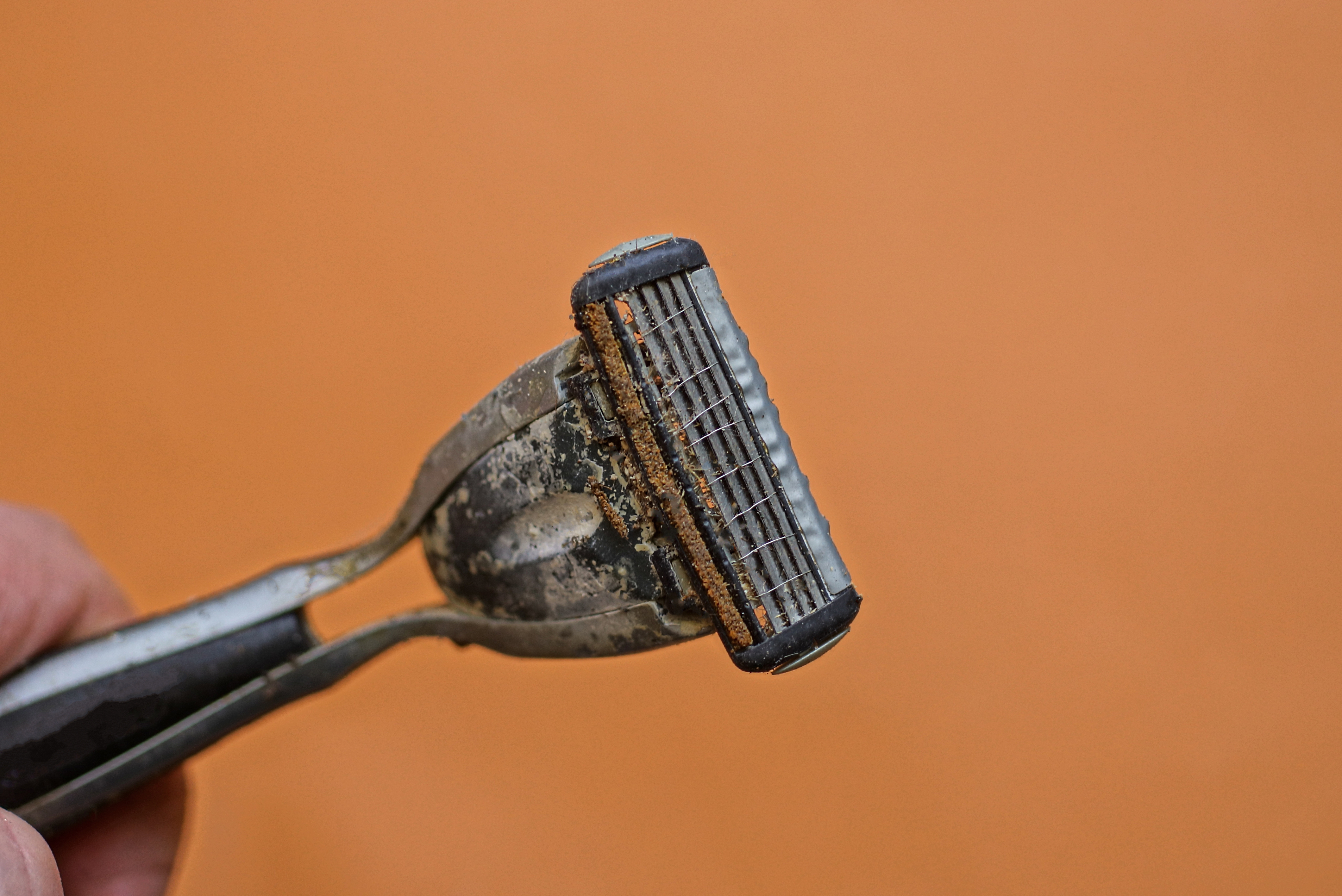One old gray and dirty razor with three blades | Source: Getty Images