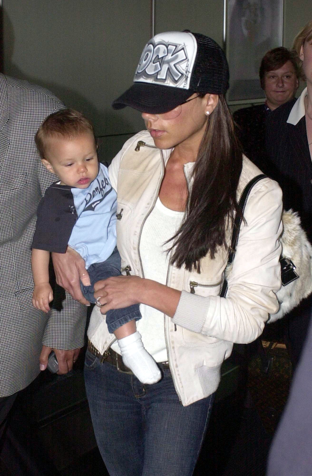 Victoria Beckham with baby Romeo in Heathrow Airport, London on 14 June 2003 | Source: Getty Images