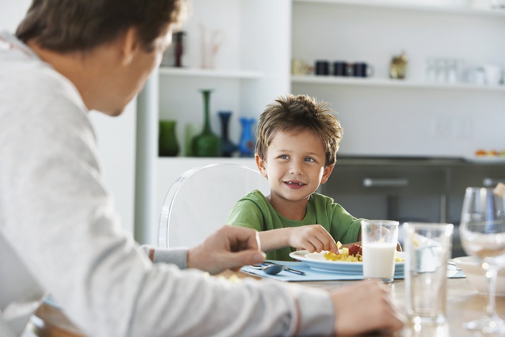 Father and son at the breakfast table | Photo: Shutterstock/sirtravelalot