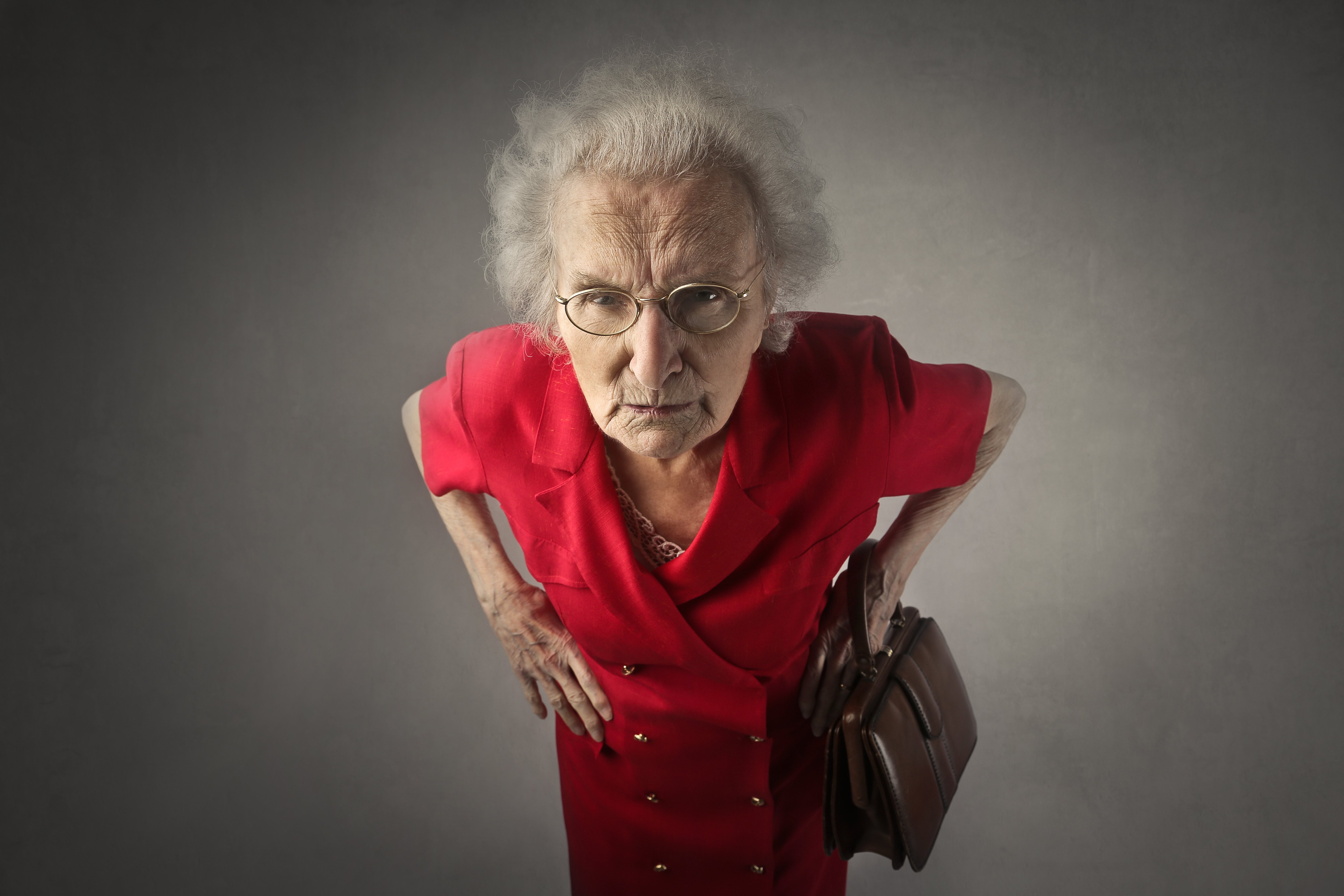 An angry lady dressed in red. | Source: Shutterstock.