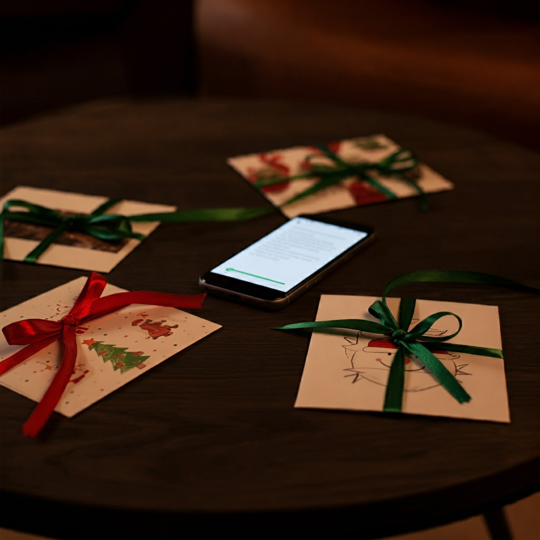 A coffee table with a phone surrounded by Christmas cards | Source: Gemini