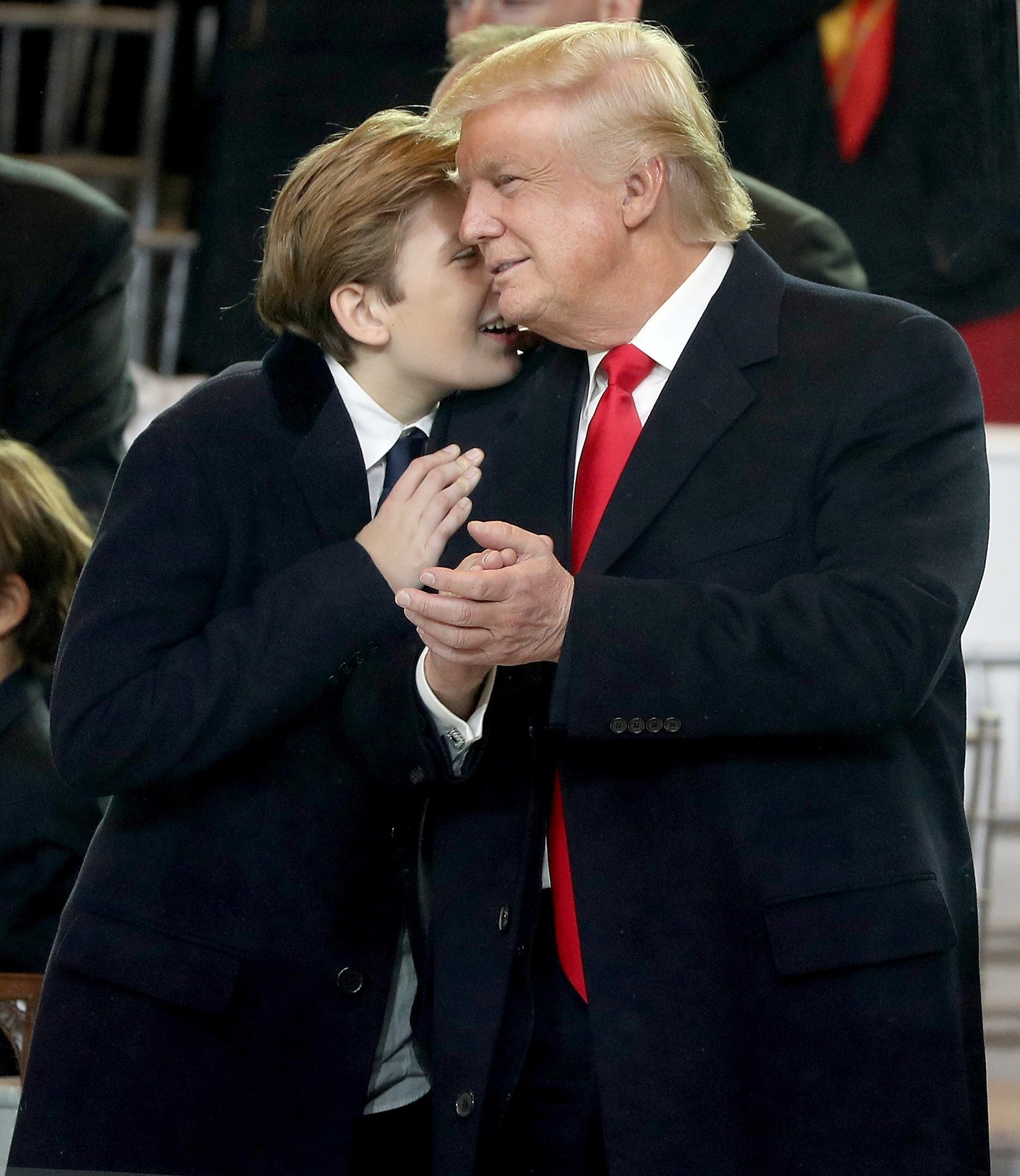 Barron Trump whispering to father President Donald Trump | Photo: Getty Images