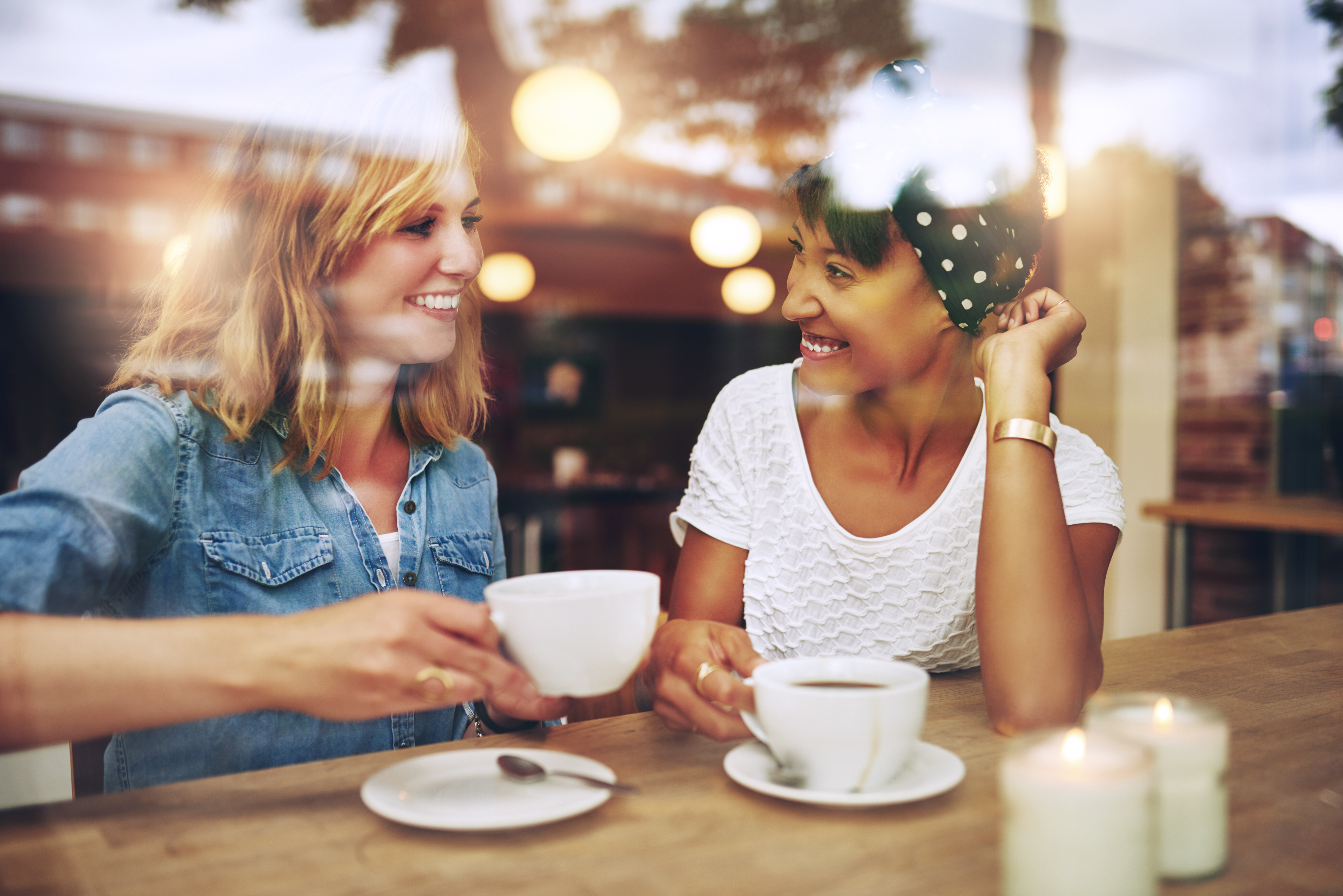 Two women enjoying coffee together in a coffee shop | Source: Shutterstock