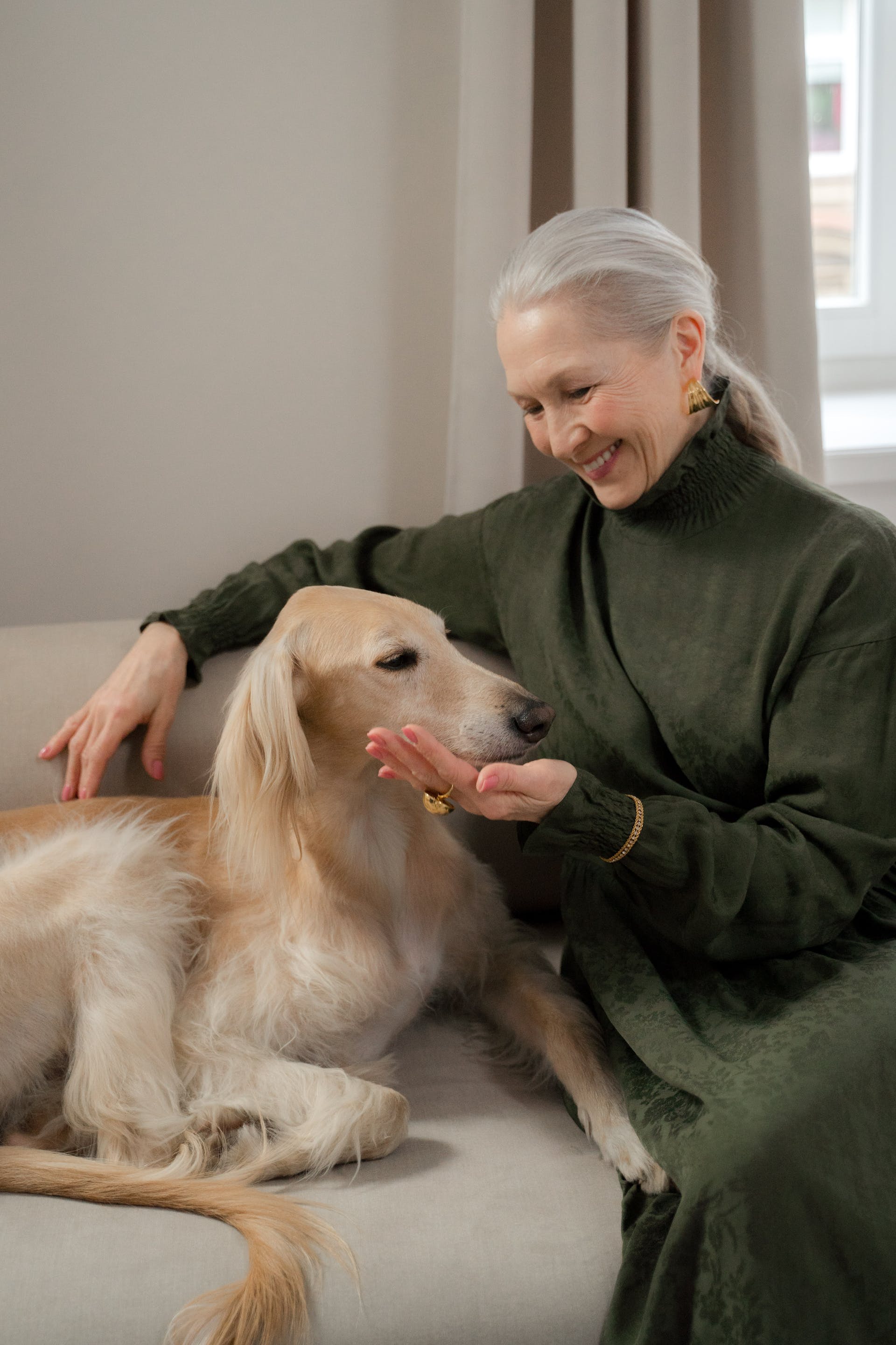 A senior woman spending time with her dog | Source: Pexels
