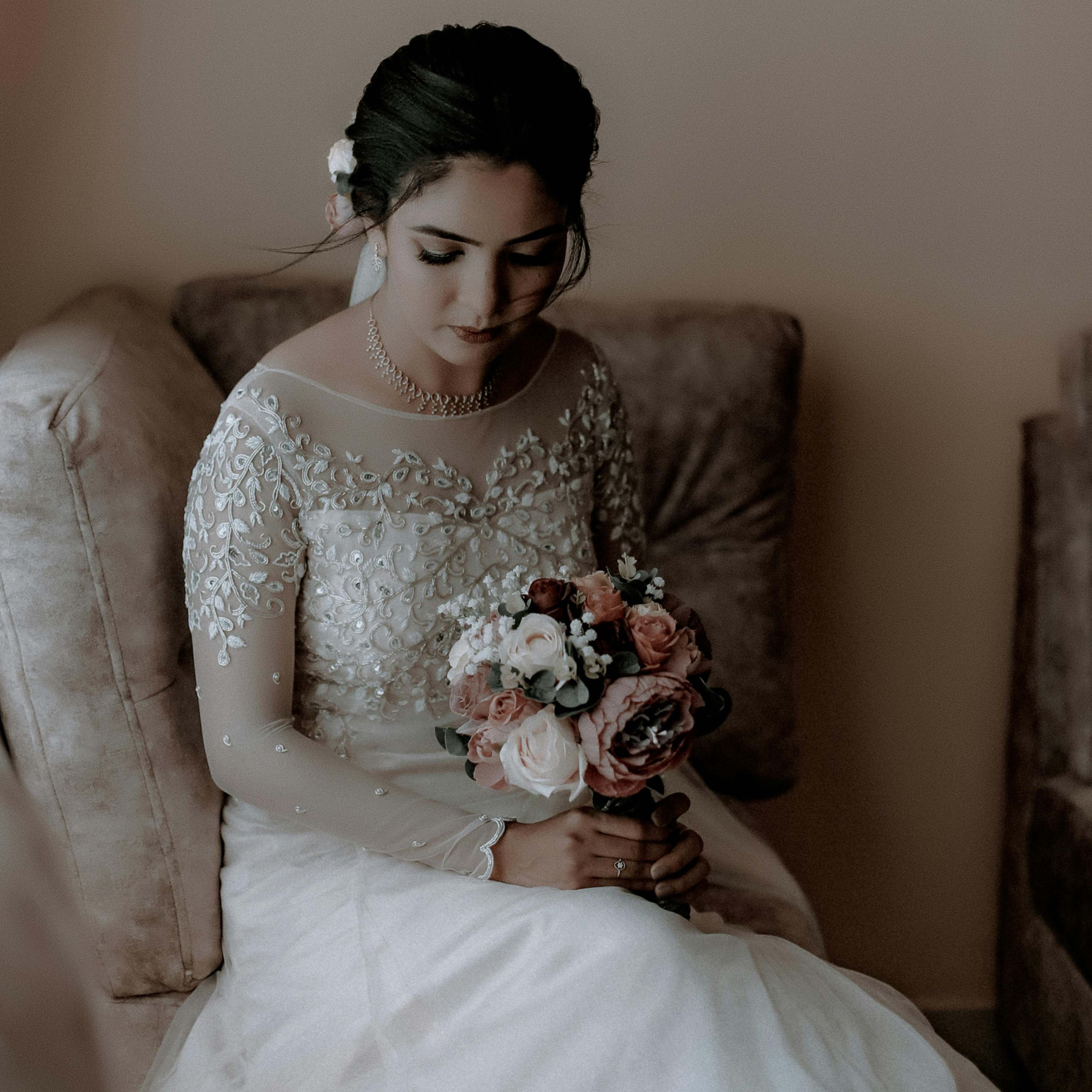 A downcast bride sitting in a chair | Source: Pexels