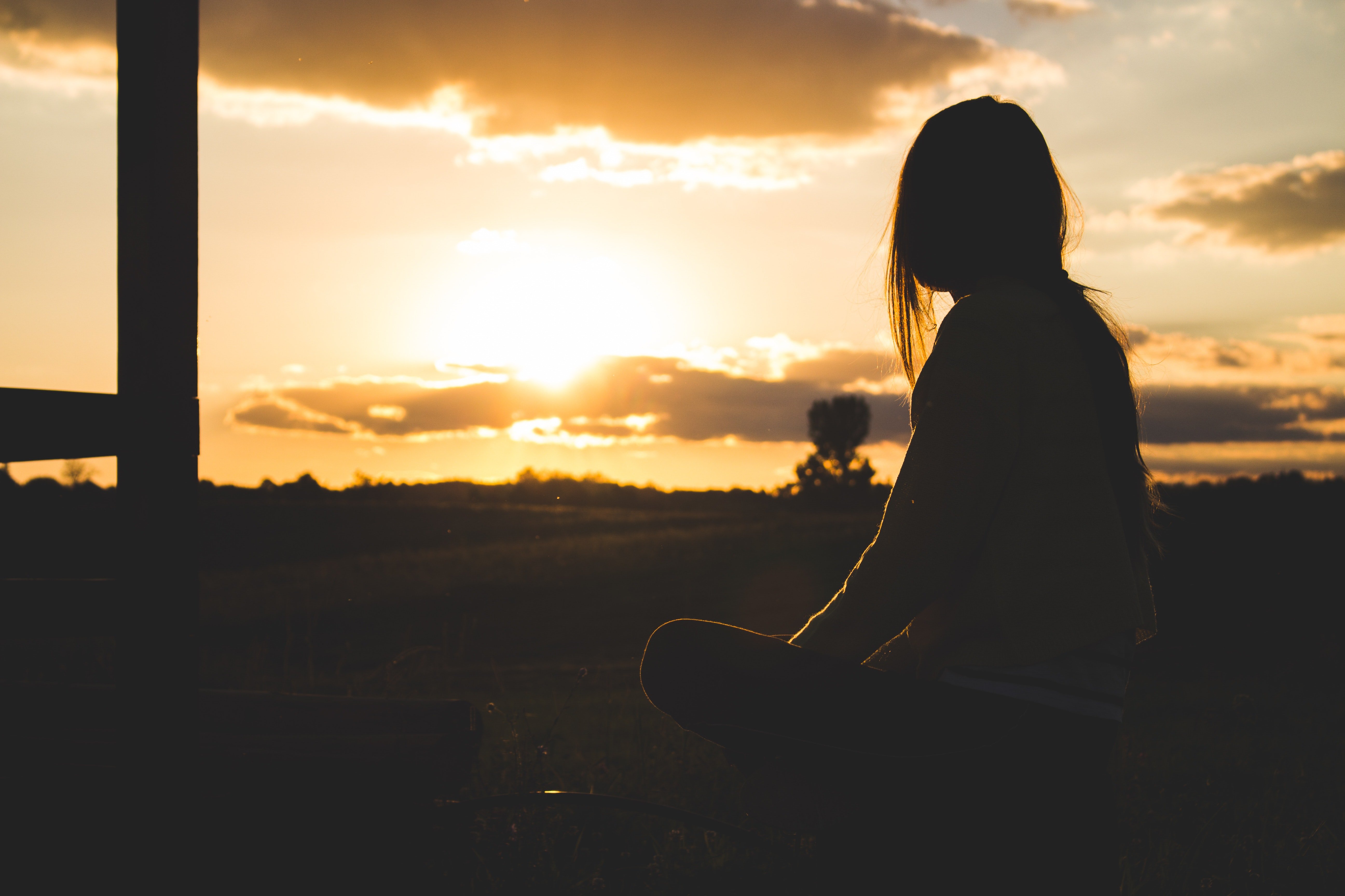 A woman sitting outside and watching the sun | Source: Pexels