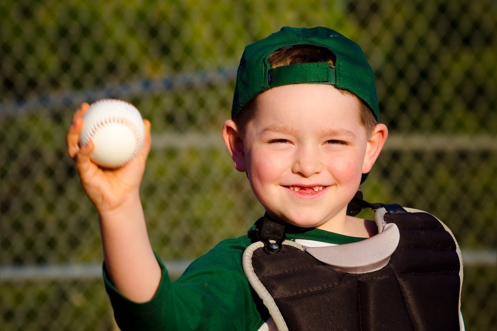 Boy with a baseball | Source: Shutterstock