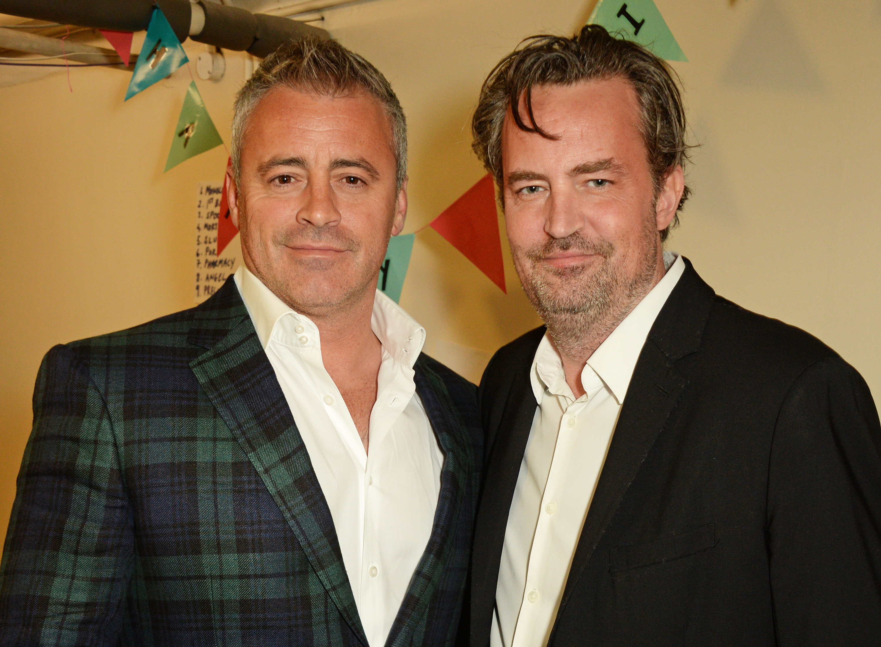 Matt LeBlanc and Matthew Perry pose backstage following a performance of "The End Of Longing" in London, England, on April 30, 2016. | Source: Getty Images