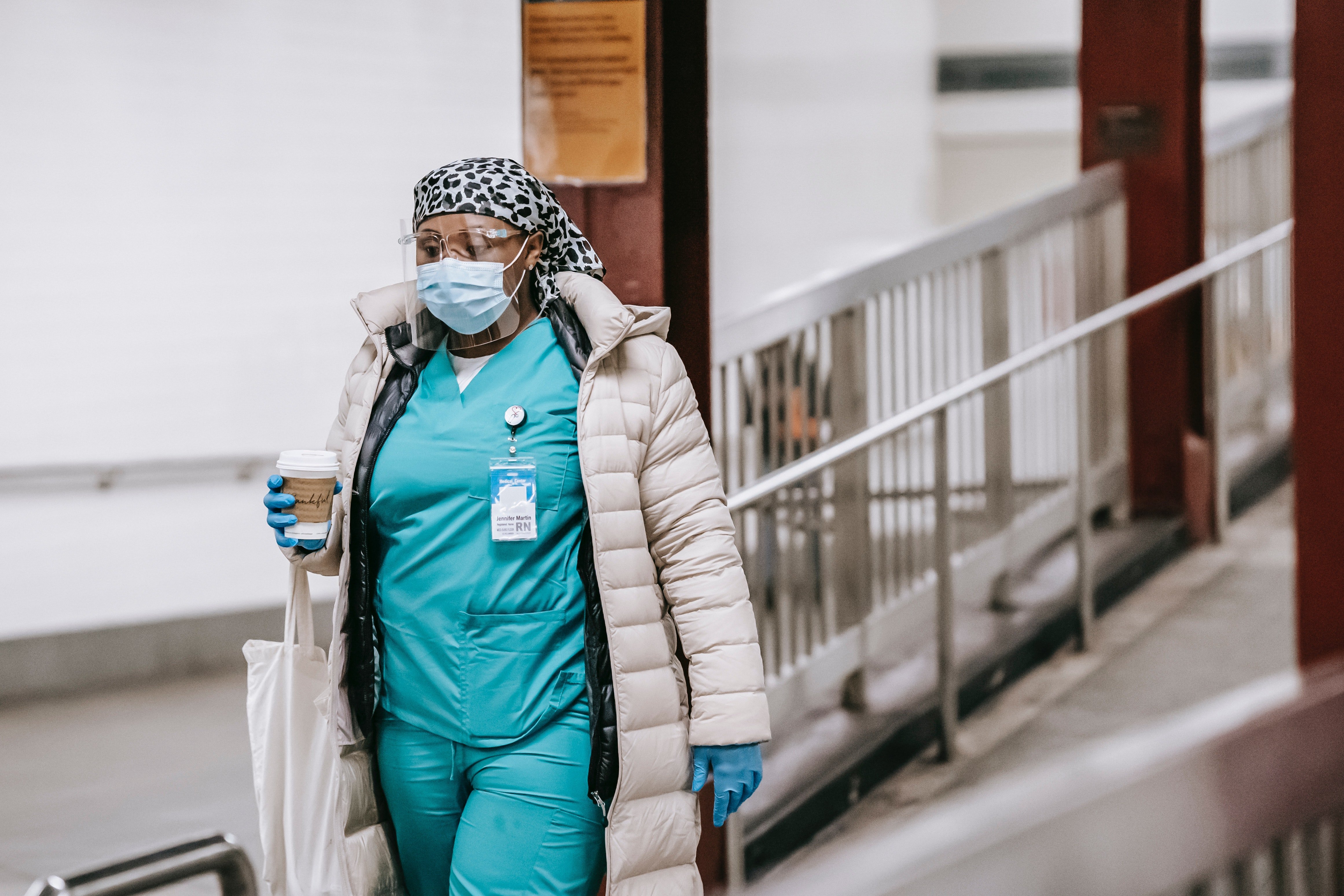 Pictured - A black female in a nurse uniform wearing protective mask and gloves | Source: Pexels 