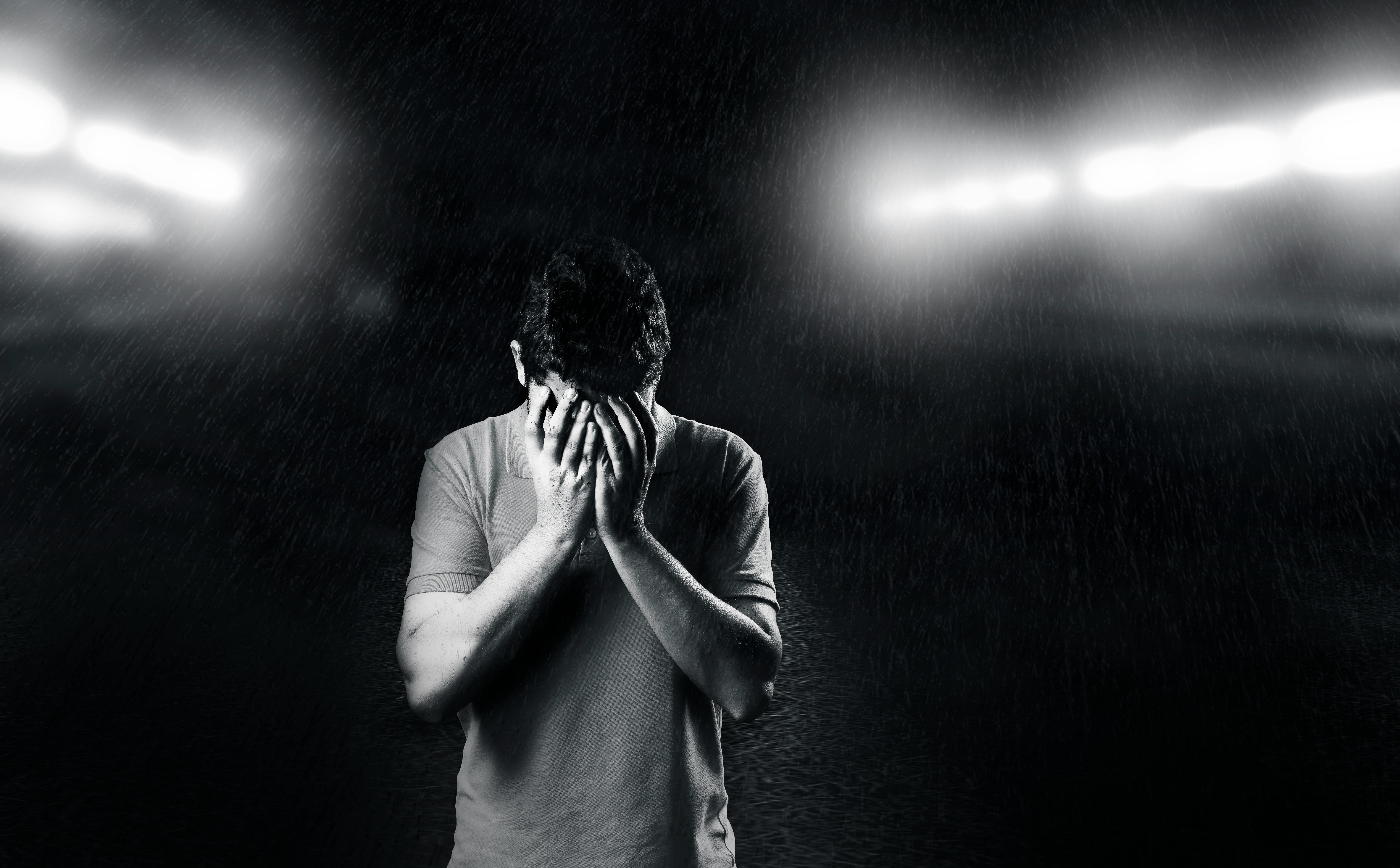 Monochrome Photo of Man Covering His Face | Source: Pexels