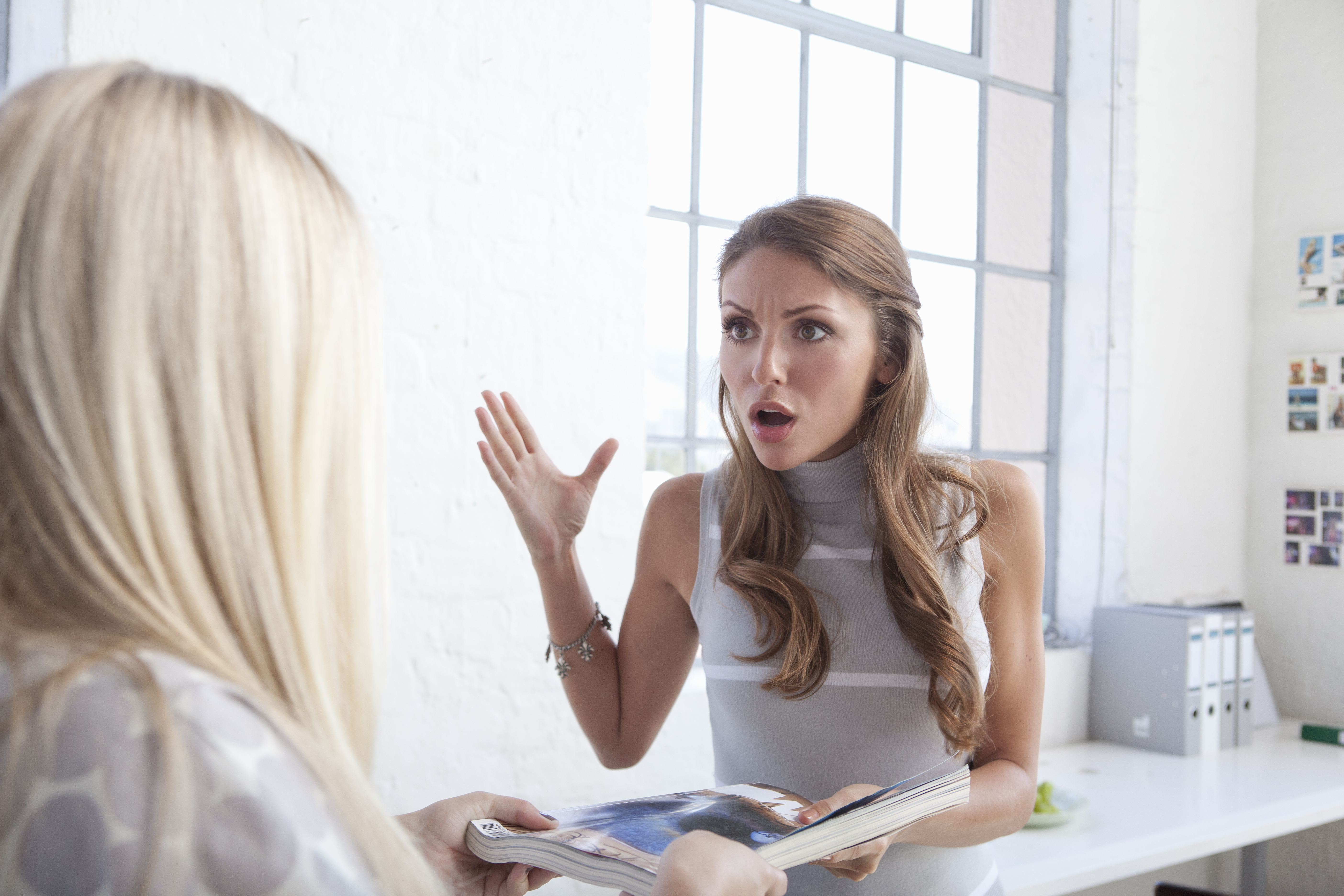 A woman is shocked while talking to another woman | Getty Images