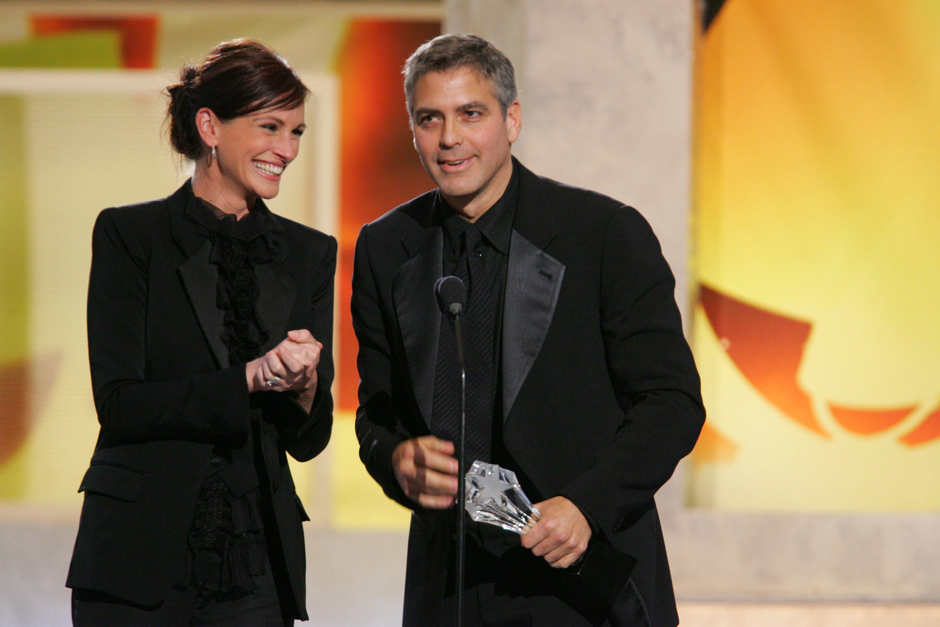 George Clooney (R), winner of the Freedom Award, with presenter Julia Roberts at the Santa Monica Civic Auditorium in Santa Monica, California. | Source: Getty Images