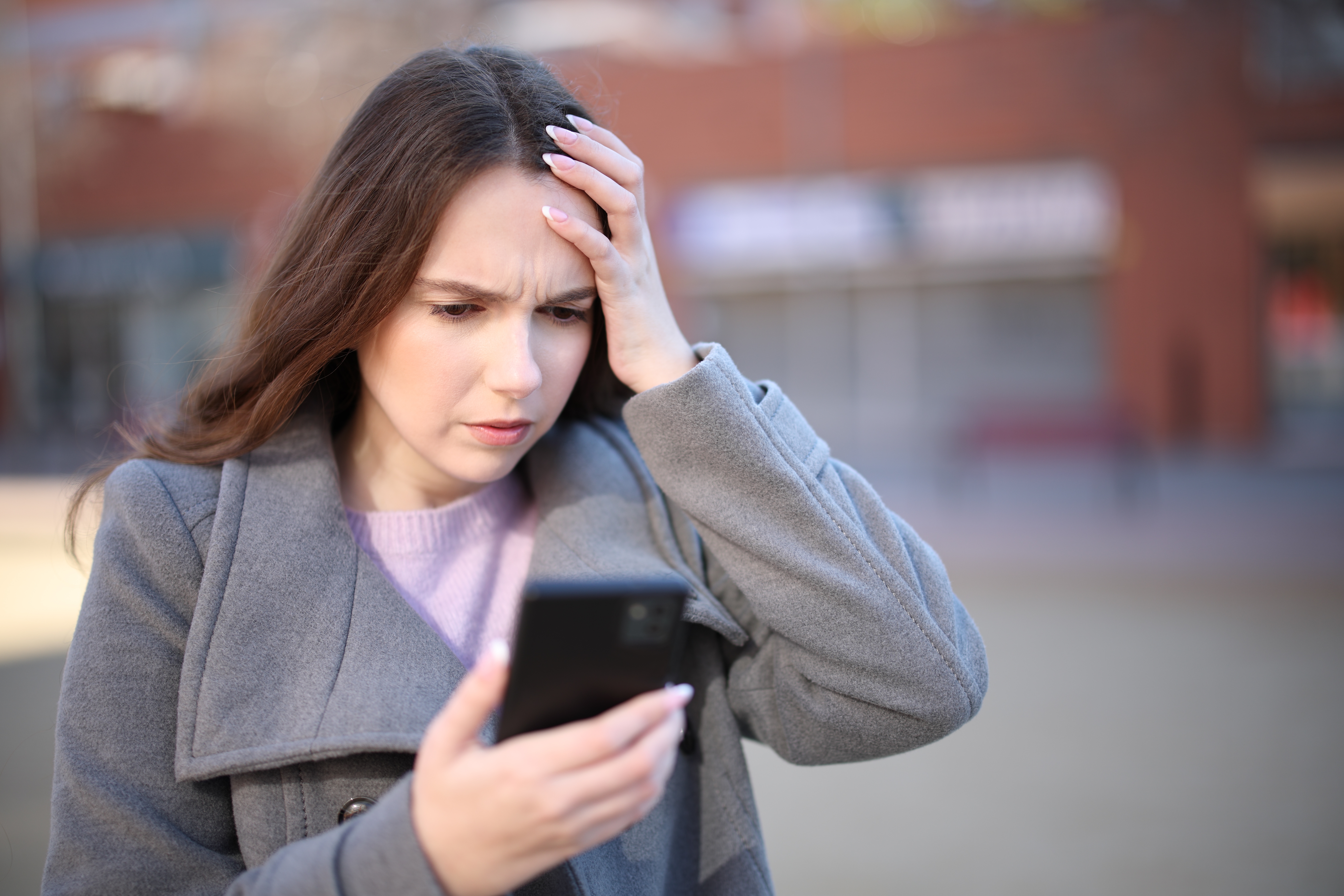 Shocked girl after bad news | Shutterstock