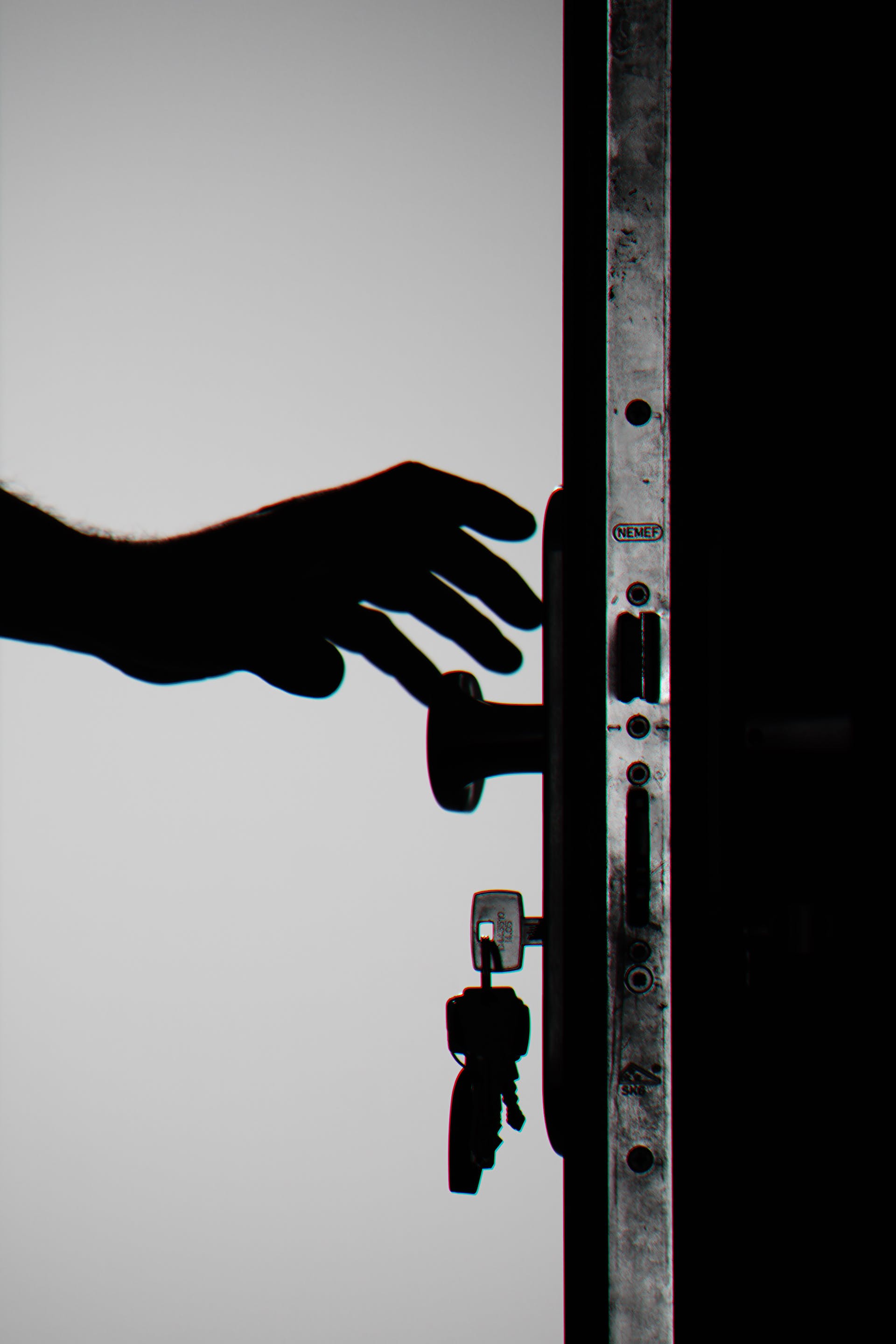 Silhouette of a person holding a door knob with the keys inside | Source: Pexels
