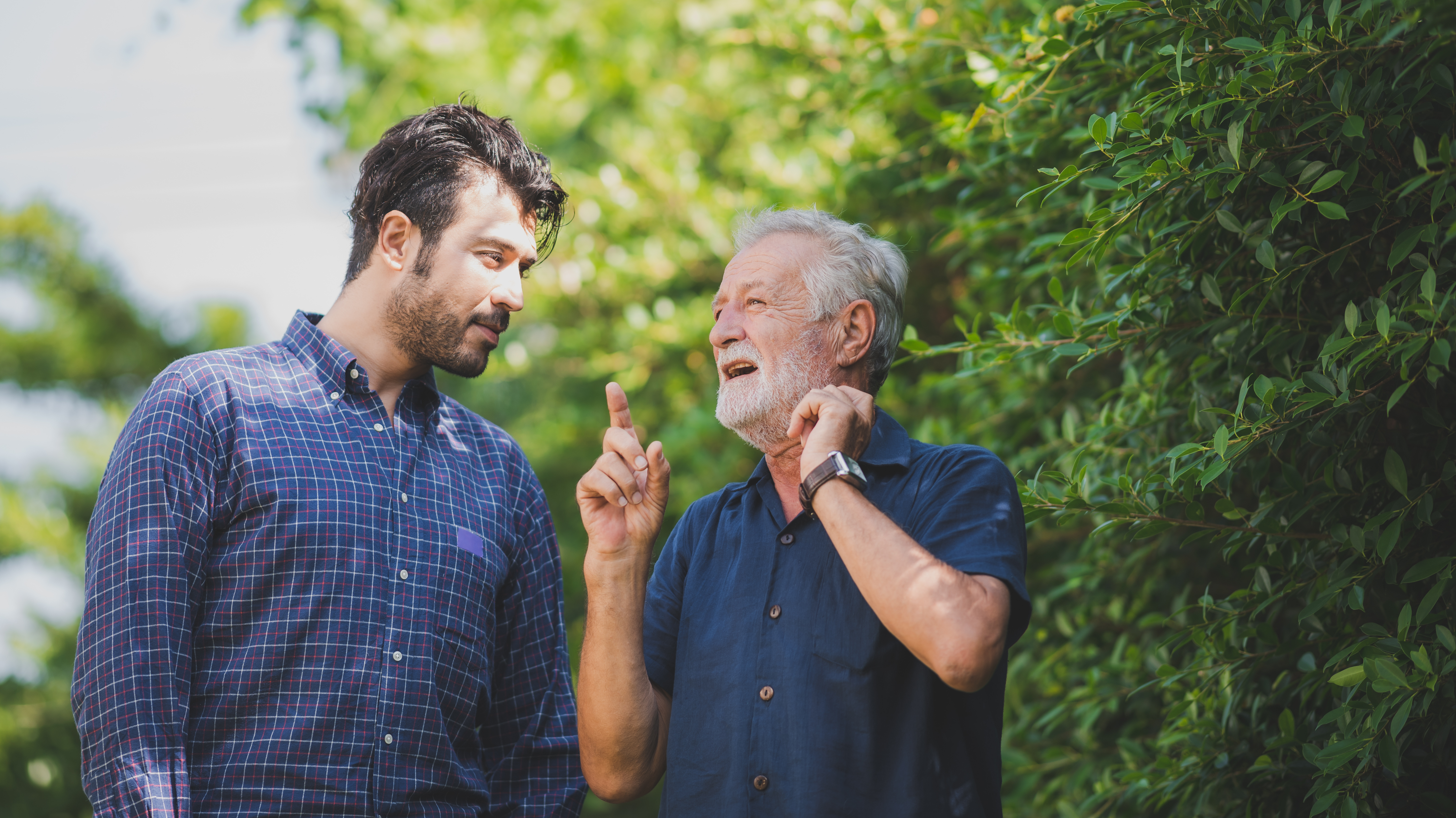 An older man bonding with a younger one outside | Source: Shutterstock