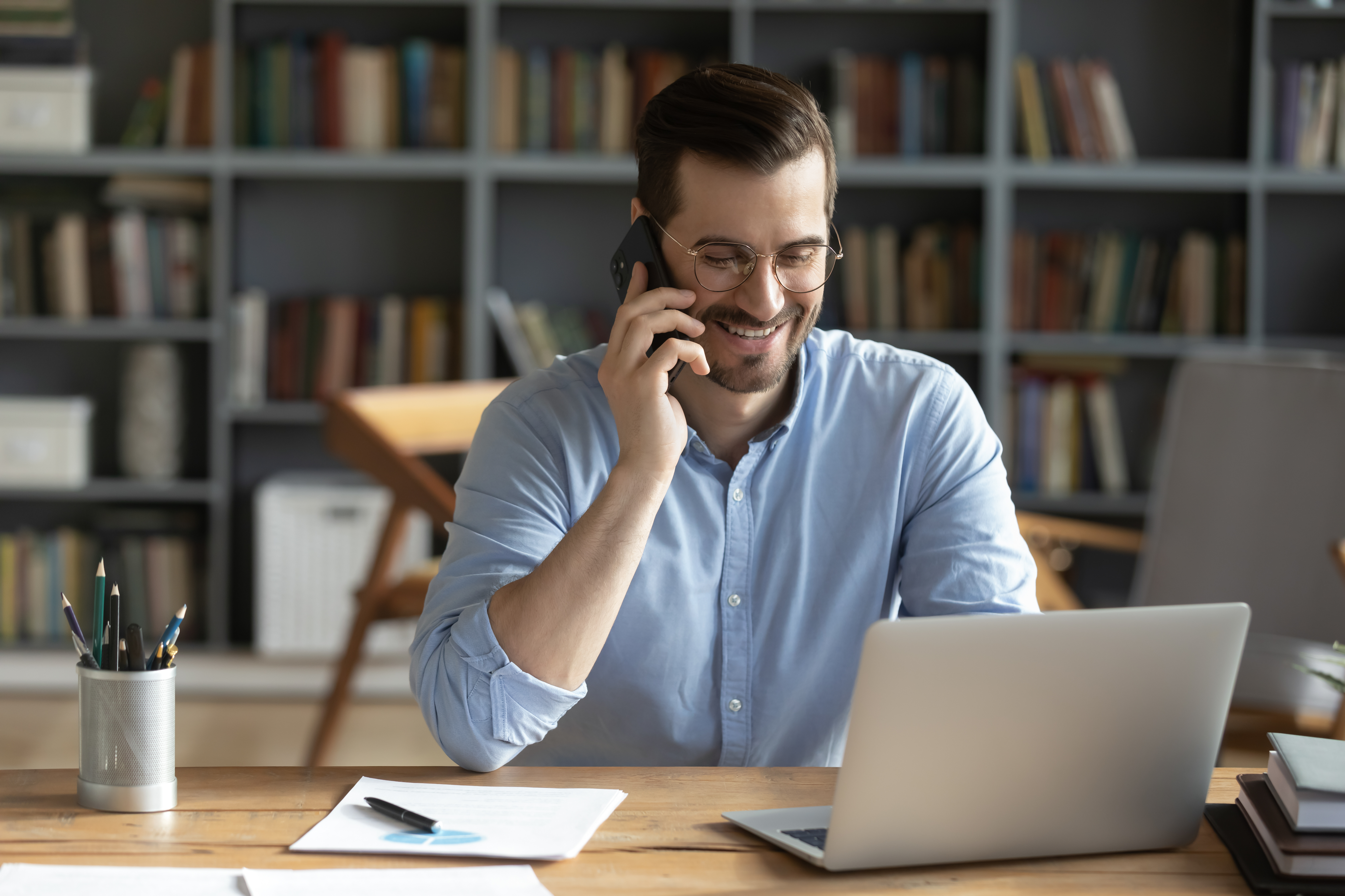 A man smiling during a phone call | Source: Shutterstock