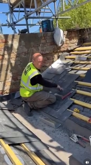 Continuing the sequence, Hendy is seen mid-motion as he adjusts roofing materials, fully immersed in the task at hand. The candid frame emphasises the hands-on skill required for the trade, with scaffolding and exposed beams surrounding him. | Source: Instagram/johnhendyeast17_official