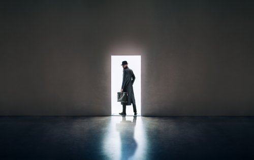 Silhouette of a man in a hat and coat. | Source: Shutterstock.