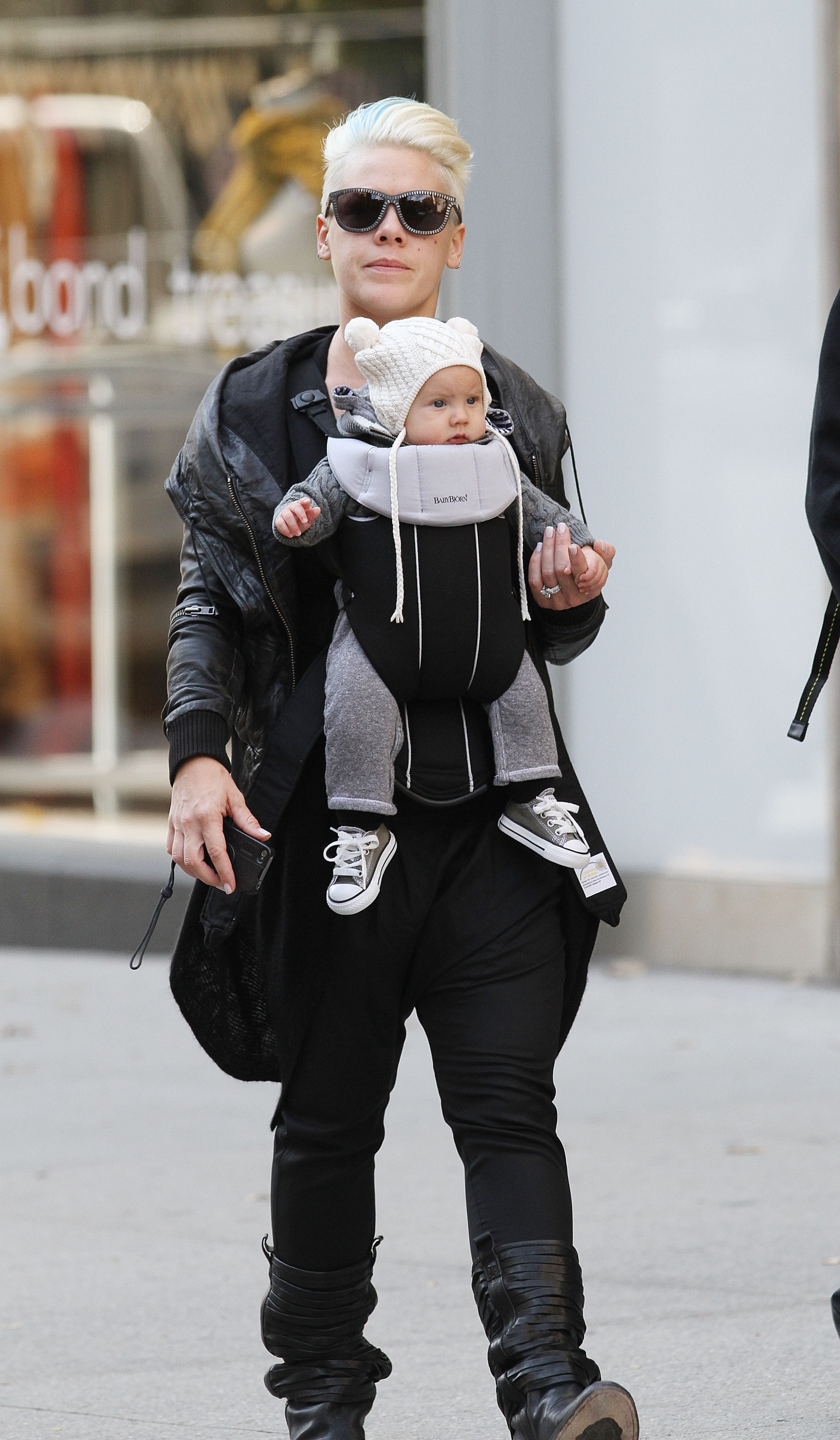Singer Pink walks through Manhattan with baby Willow Sage Hart secured in a front carrier on October 23. In sunglasses and a black leather jacket, Pink keeps the outing low-key while Willow peers out in a knit hat.