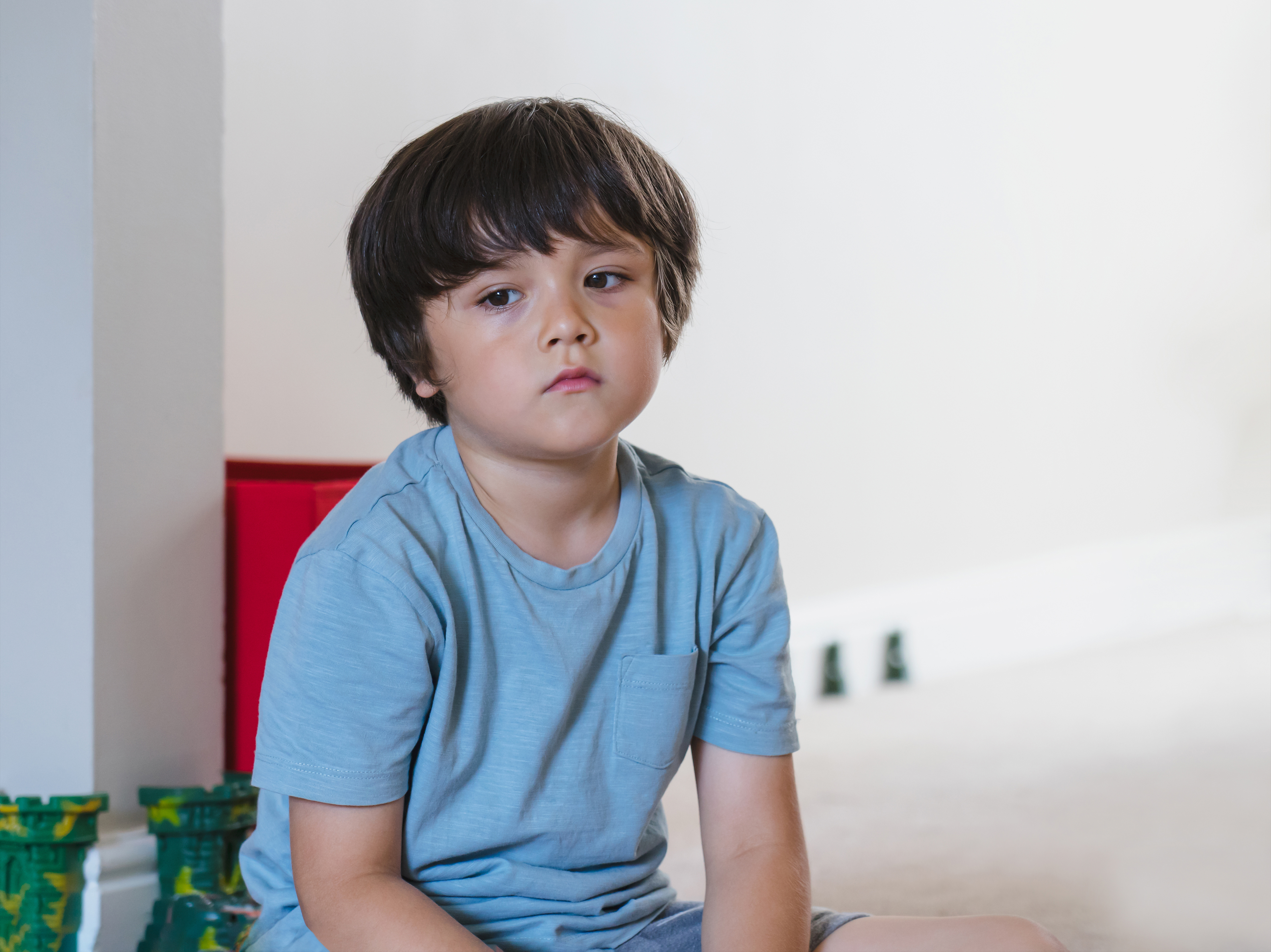Sad boy is sitting on the chair | Source: Shutterstock.com