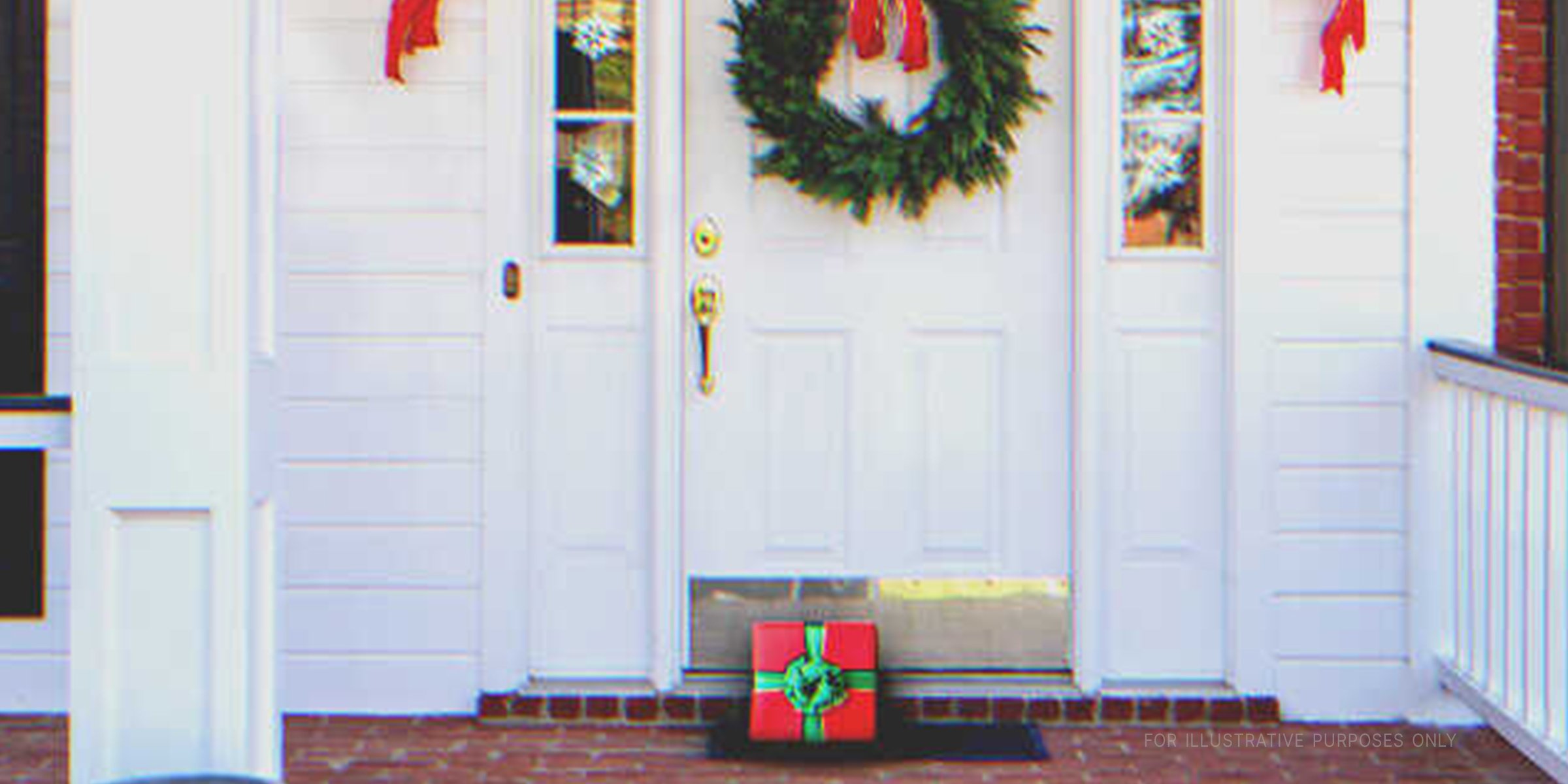 Front door with a present on the floor. | Source: Shutterstock