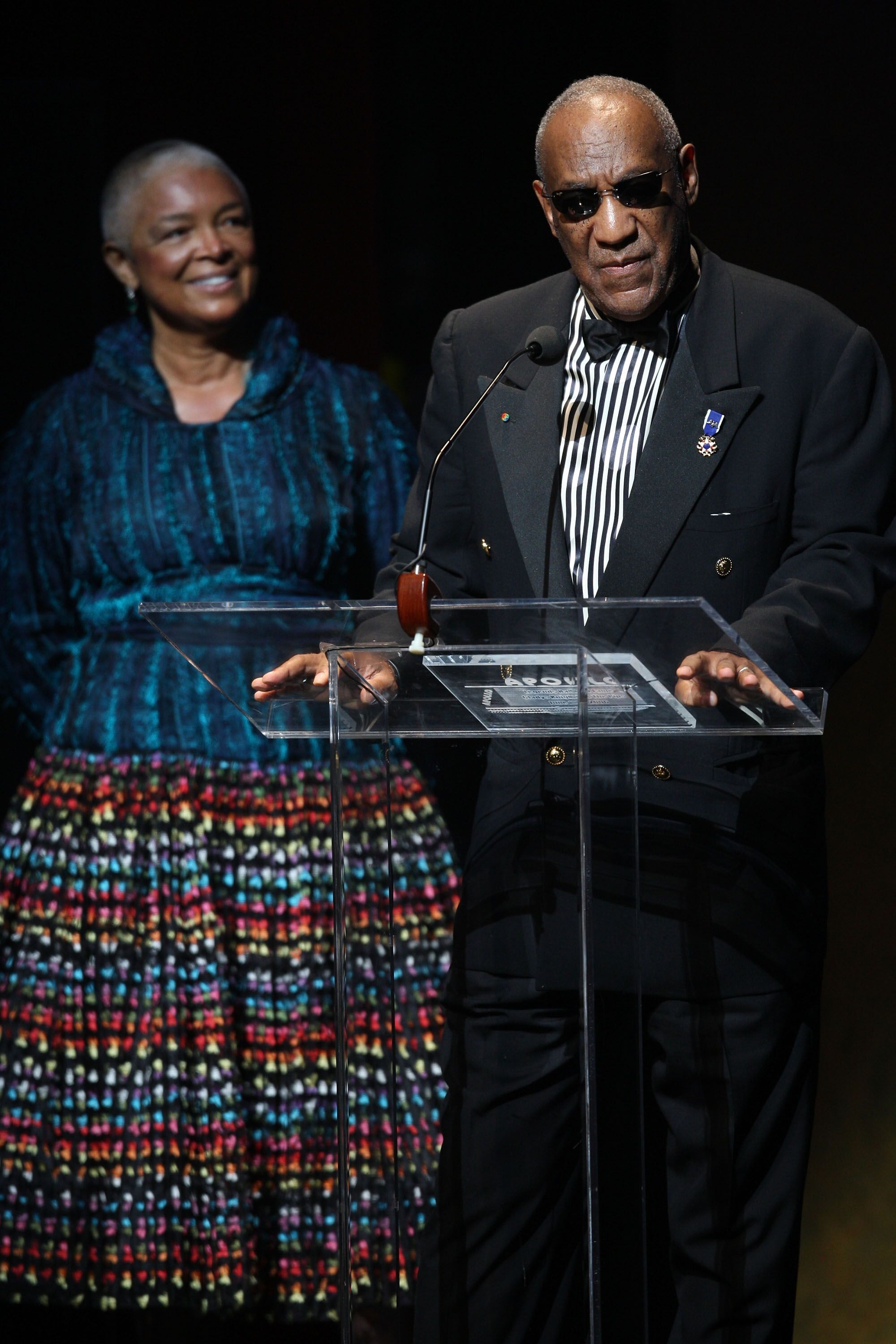 Bill Cosby giving a speech as wife Camille looks on | Source: Getty Images