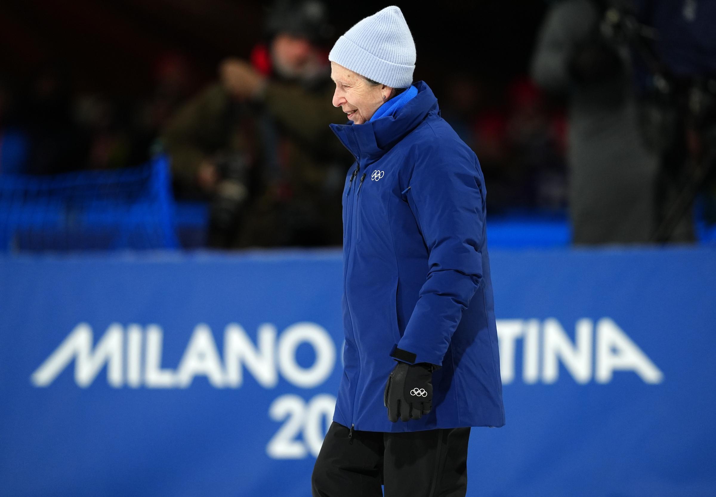 Princess Anne stepped forward at Livigno Snow Park to present medals for the Women's Snowboard Big Air Final on February 9, 2026, her arrival framed by the bold Milano Cortina signage behind her. Dressed in a rich blue winter coat, grey knit hat, and black gloves marked with the Olympic rings, she appeared focused and purposeful.