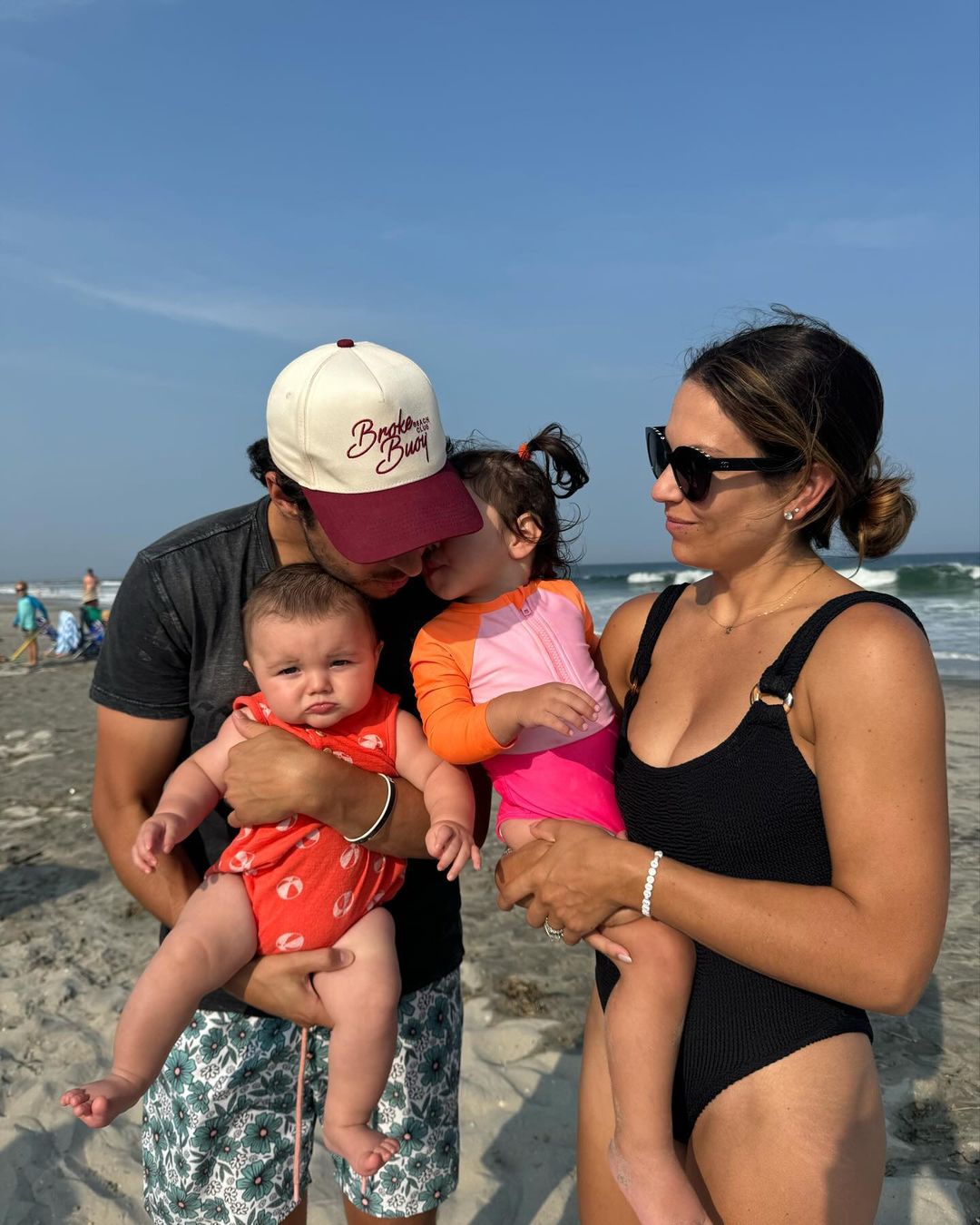 Johnny, baby Johnny, Noa, and Meredith Gaudreau enjoying family time at the beach, from an Instagram slideshow of pictures, dated September 1, 2024 | Source: Instagram/meredithgaudreau_