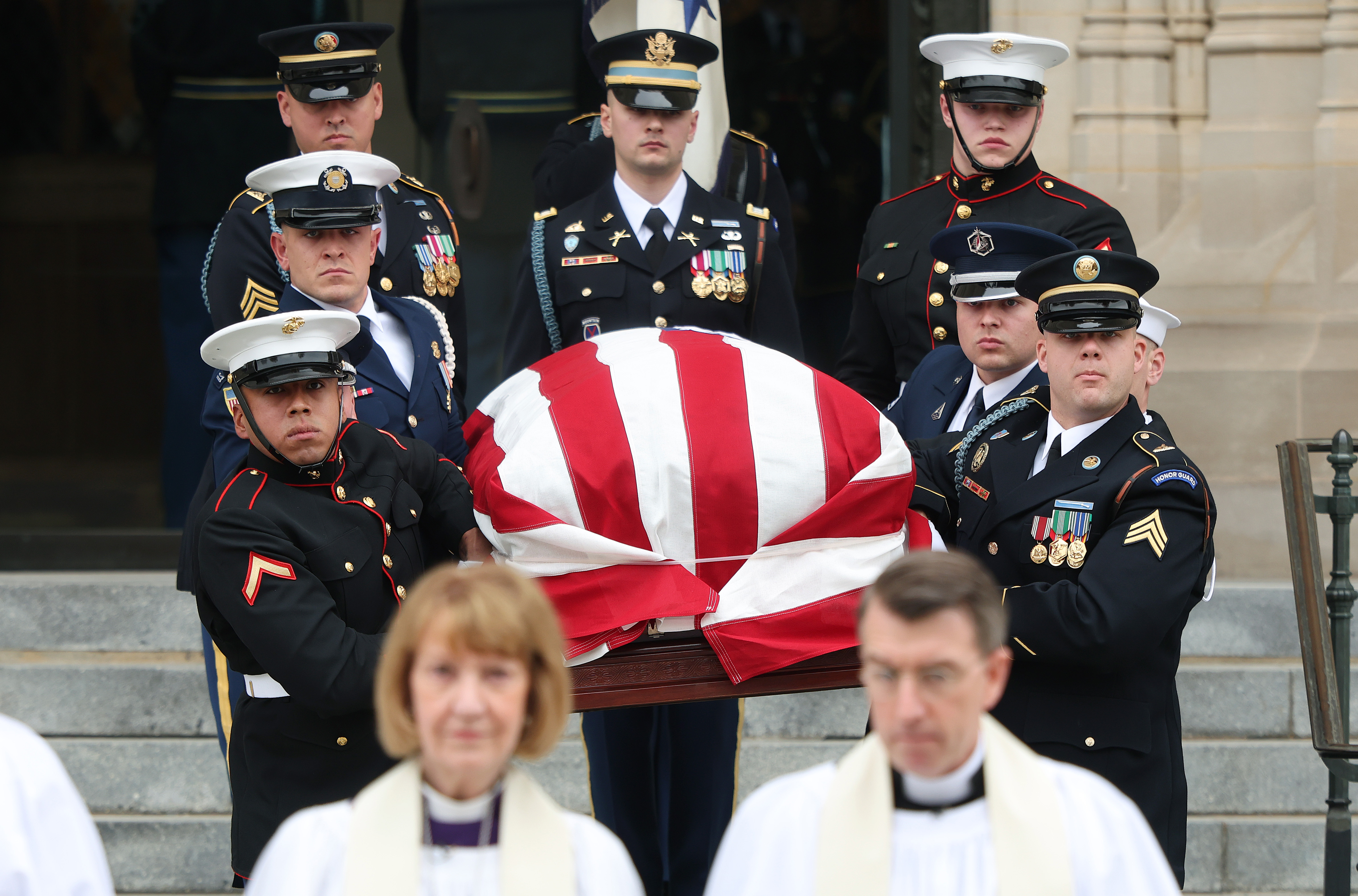 U.S. military body bearers carry the casket containing the remains of former Vice President Dick Cheney out of the National Cathedral during Cheney's funeral service on November 20, 2025 in Washington, DC.