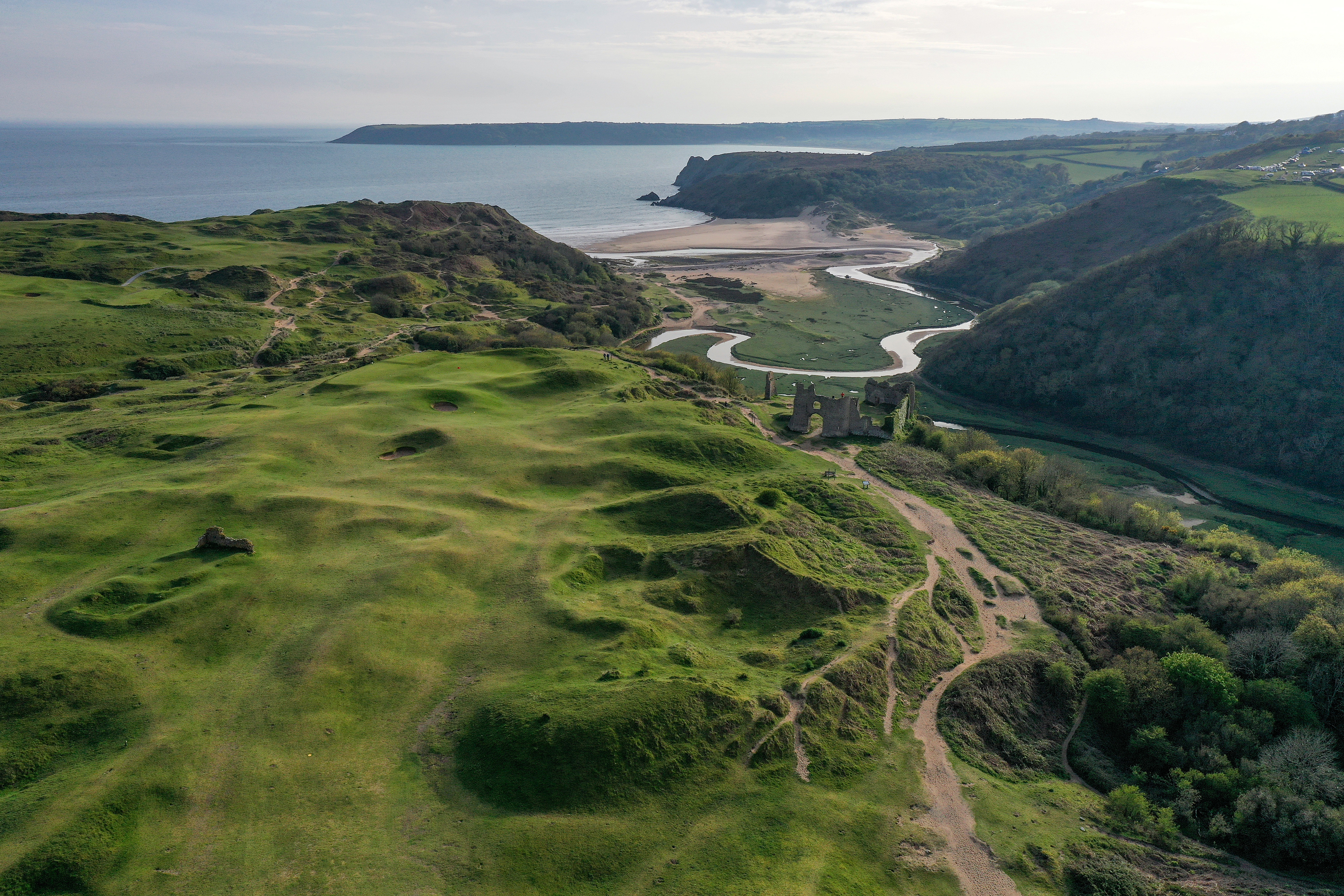 An aerial view of the par 4, seventh hole 'Castle' looking towards the Three Cliffs Bay at Pennard Golf Club on May 2, 2023, in Swansea, Wales. | Source: Getty Images