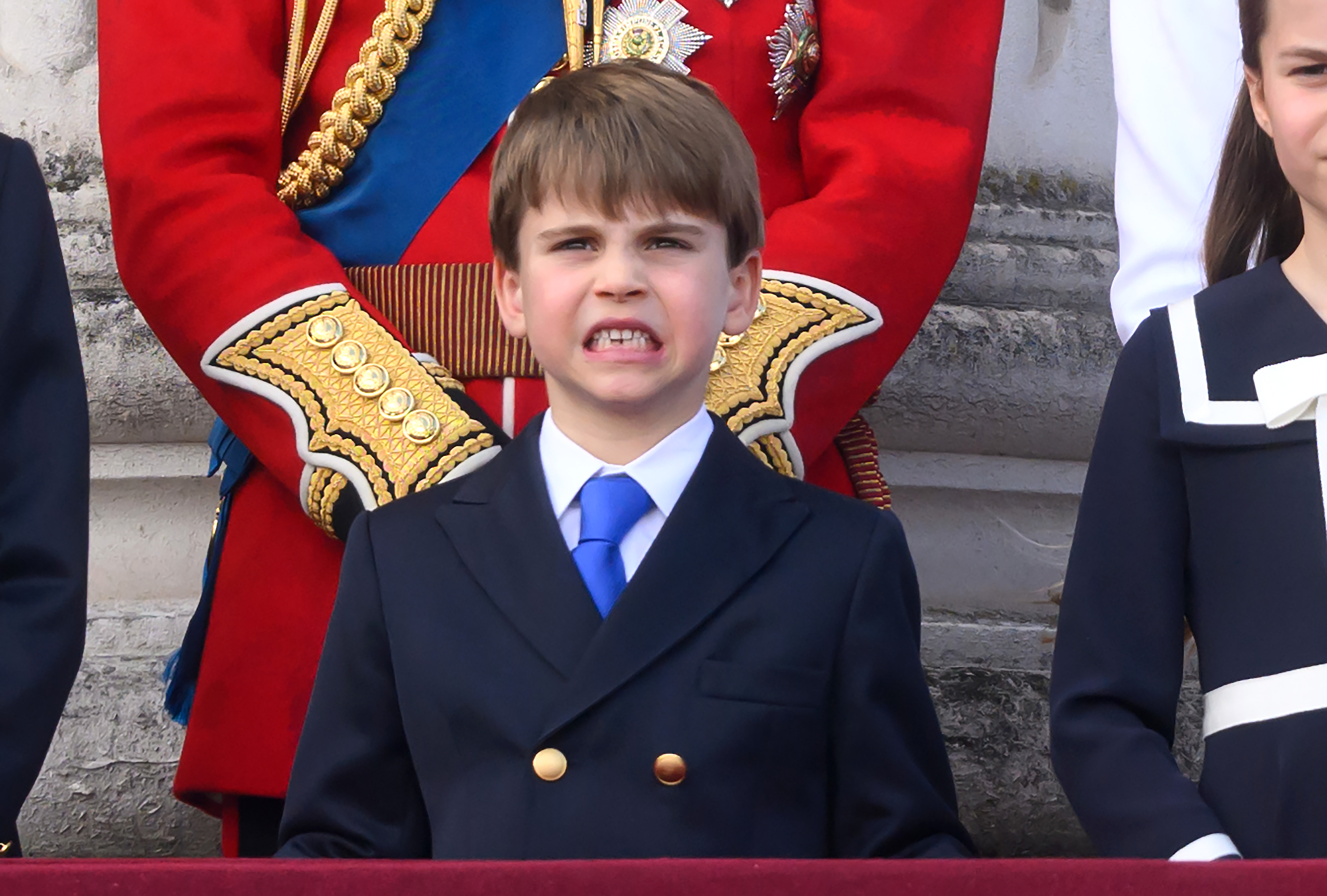 Prince Louis grins as he watches the Royal Air Force flypast from Buckingham Palace's balcony after Trooping the Colour in London on June 15, 2024. | Source: Getty Images