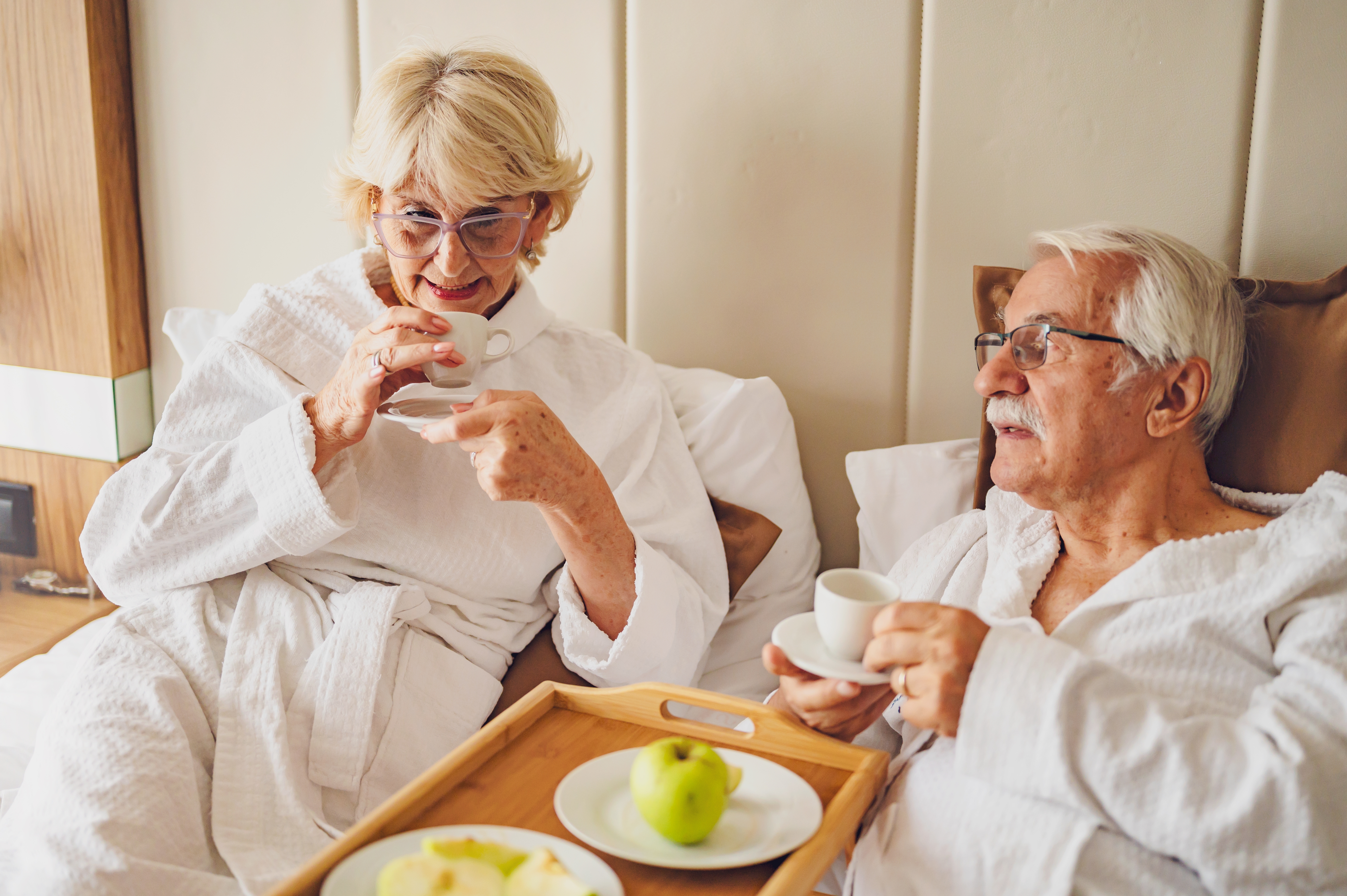 An elderly man and woman in a hotel room | Source: Shutterstock