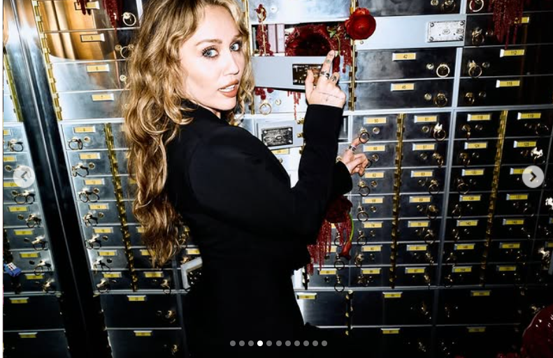 Miley Cyrus strikes a playful yet commanding pose in front of a wall of metallic safety deposit boxes, as seen from her post dated October 25, 2025 | Source: Instagram/mileycyrus