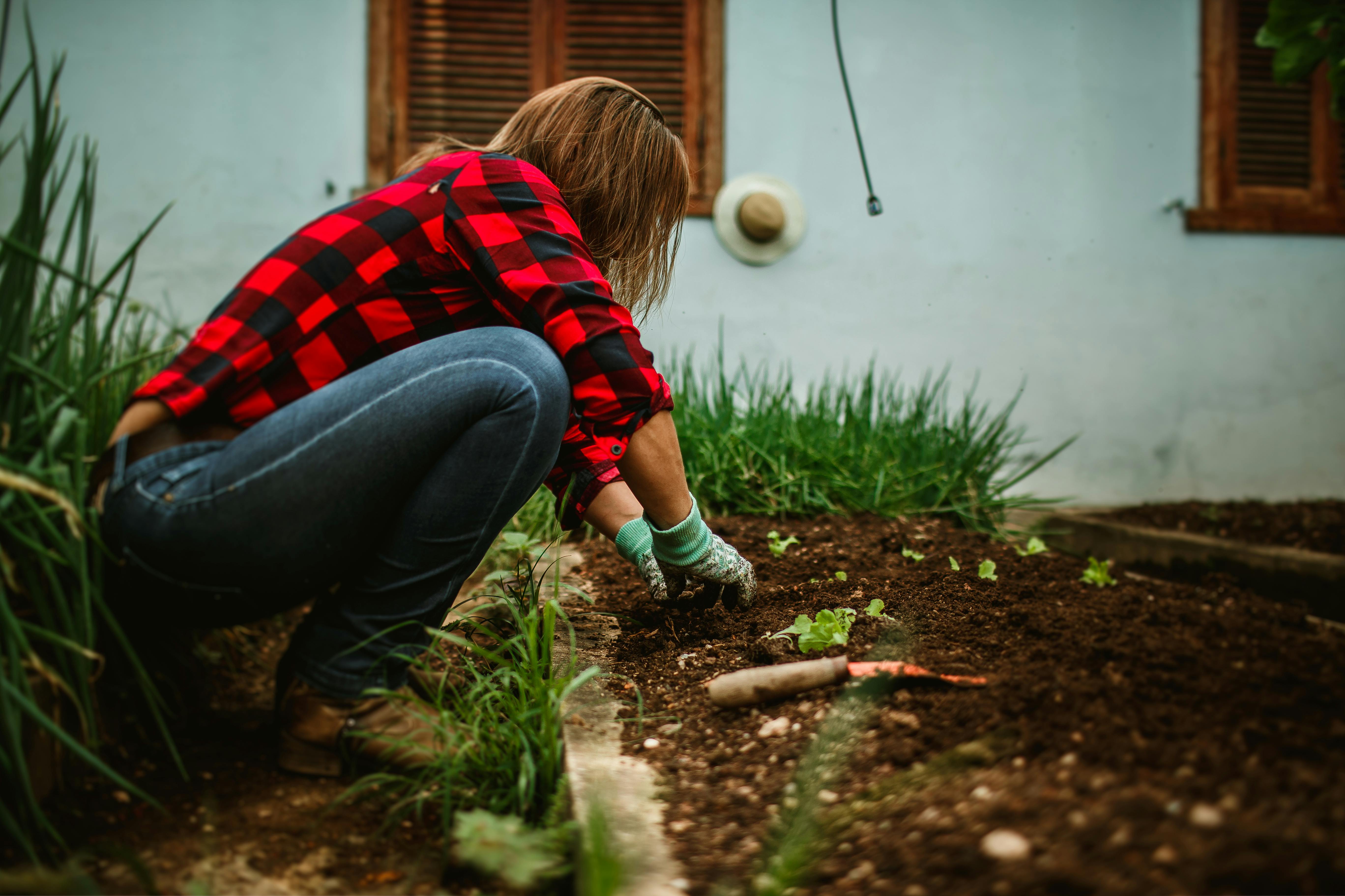 A woman checking her garden's soil | Source: Pexels