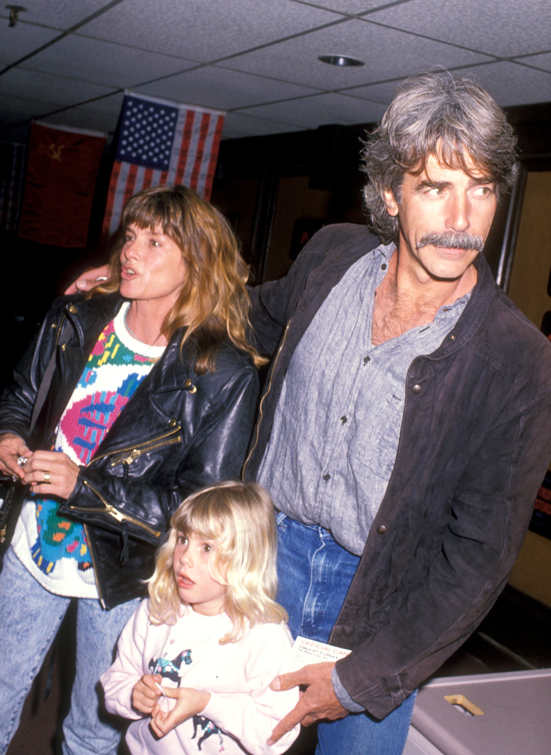 Actors Katharine Ross, Sam Elliott, and daughter Cleo Elliott attend an event on March 14, 1990 at Great Western Forum in Inglewood, California. | Source: Getty Images
