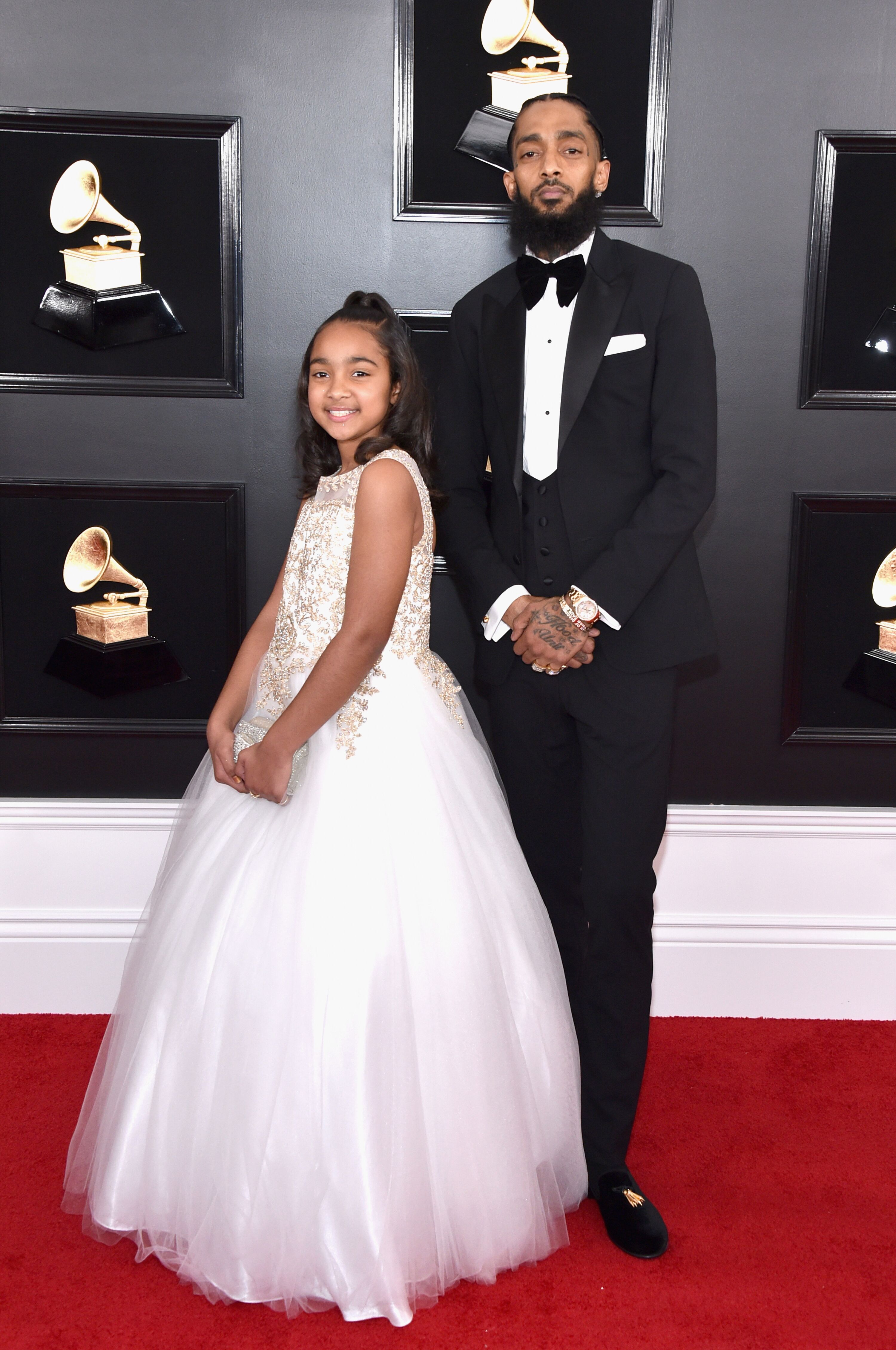 Nipsey Hussle with his daughter Emani at the 61st Grammy Awards in 2019/ Source; Getty Images